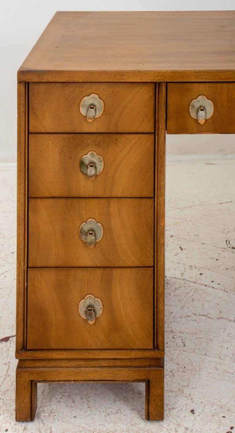 Mid-Century Asian Modern Walnut Kneehole Desk by Landstrom Furniture, 1960's, rectangular, with three short drawers above pedetals with two long drawers each side of the kneehole, the drawers with Japanese Tsuba-form backplates with teardrop pulls.