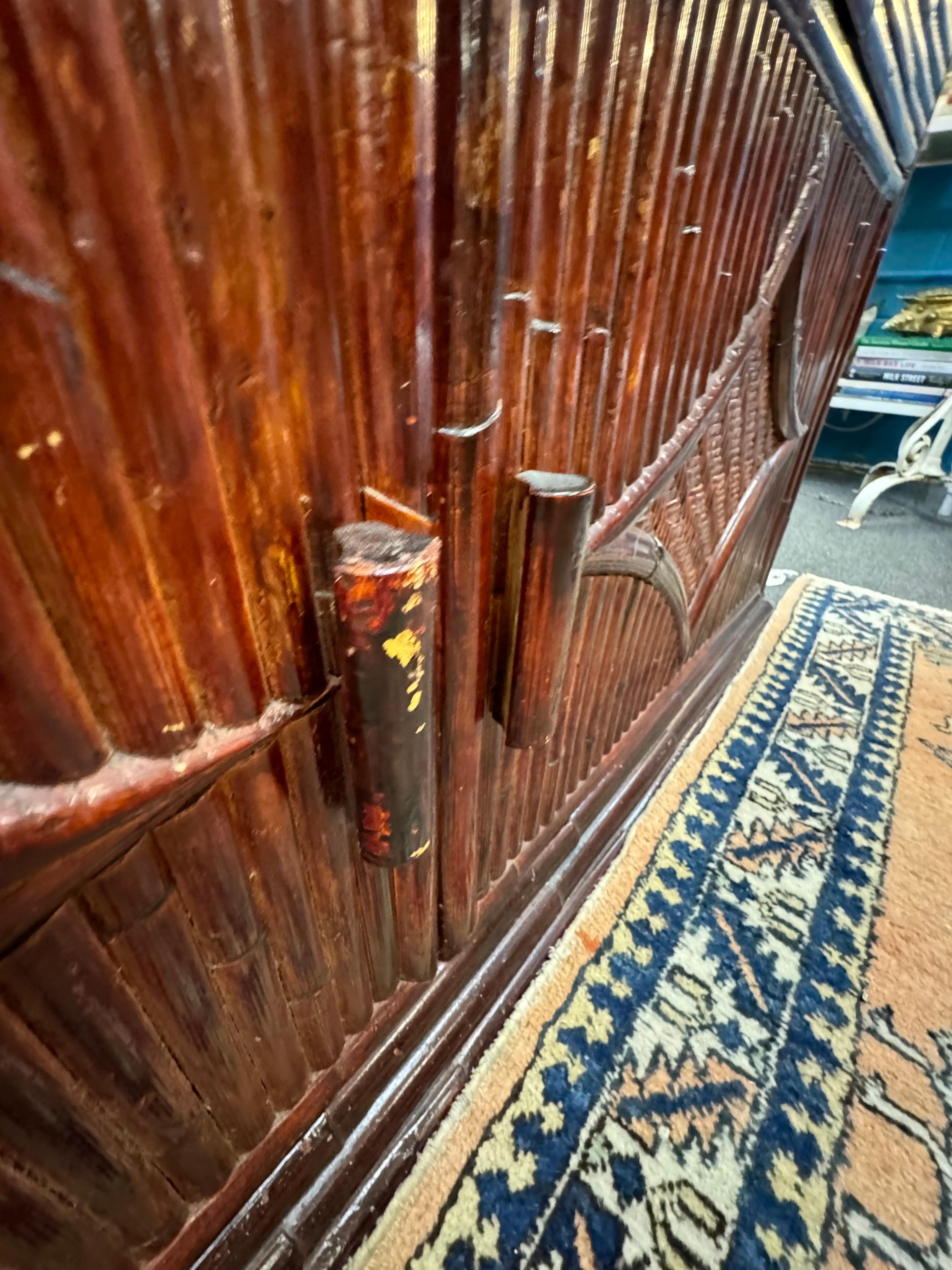 This is a beautiful piece of furniture, a vintage bamboo pagoda-style hutch from the 1970’s. The design reflects Asian architectural influences, evident in the pagoda-like structure and the use of bamboo motifs. The craftsmanship is detailed,