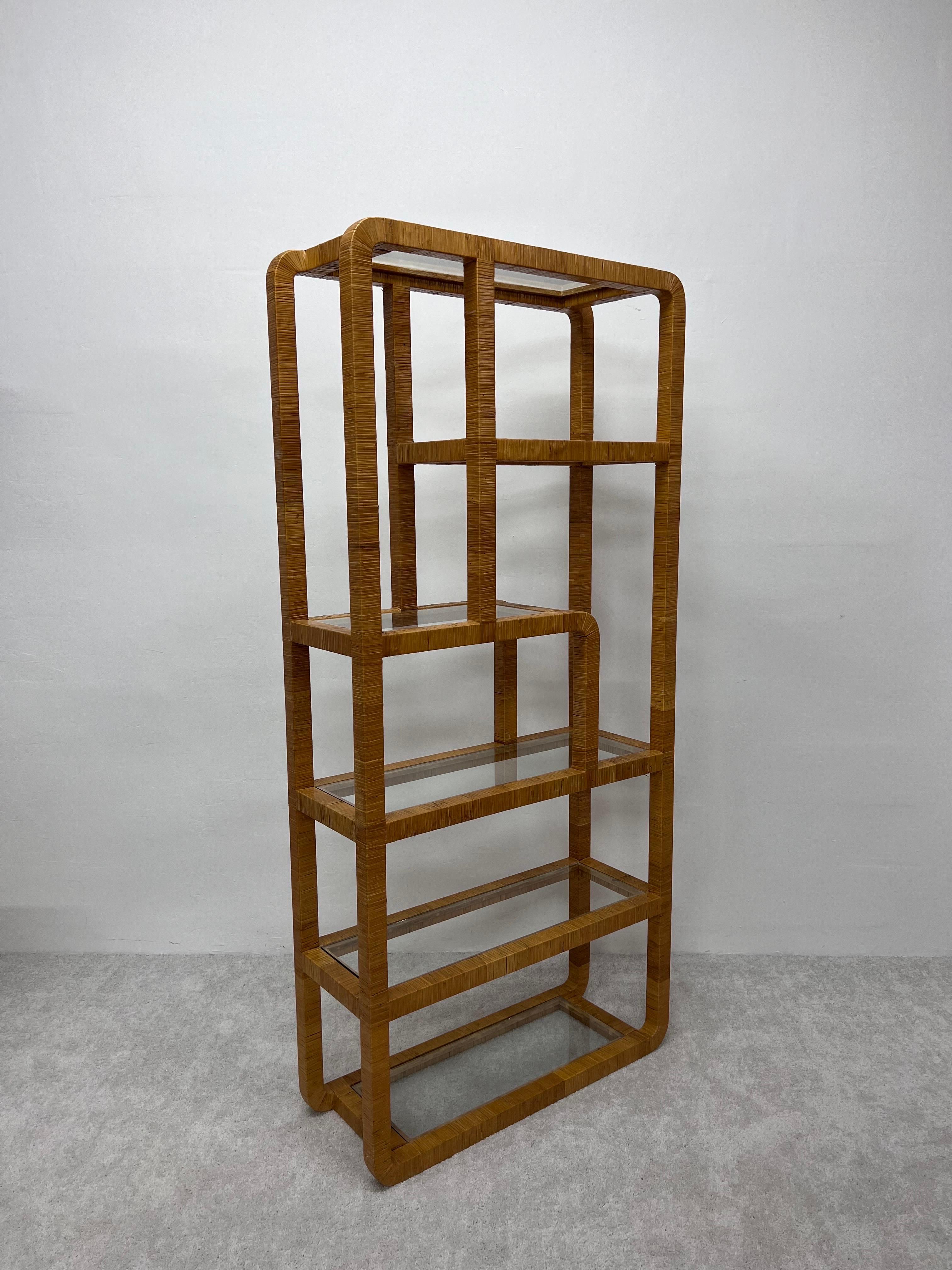 Woven rattan wrapped assymetrical etagere with glass shelves from the 1970s.