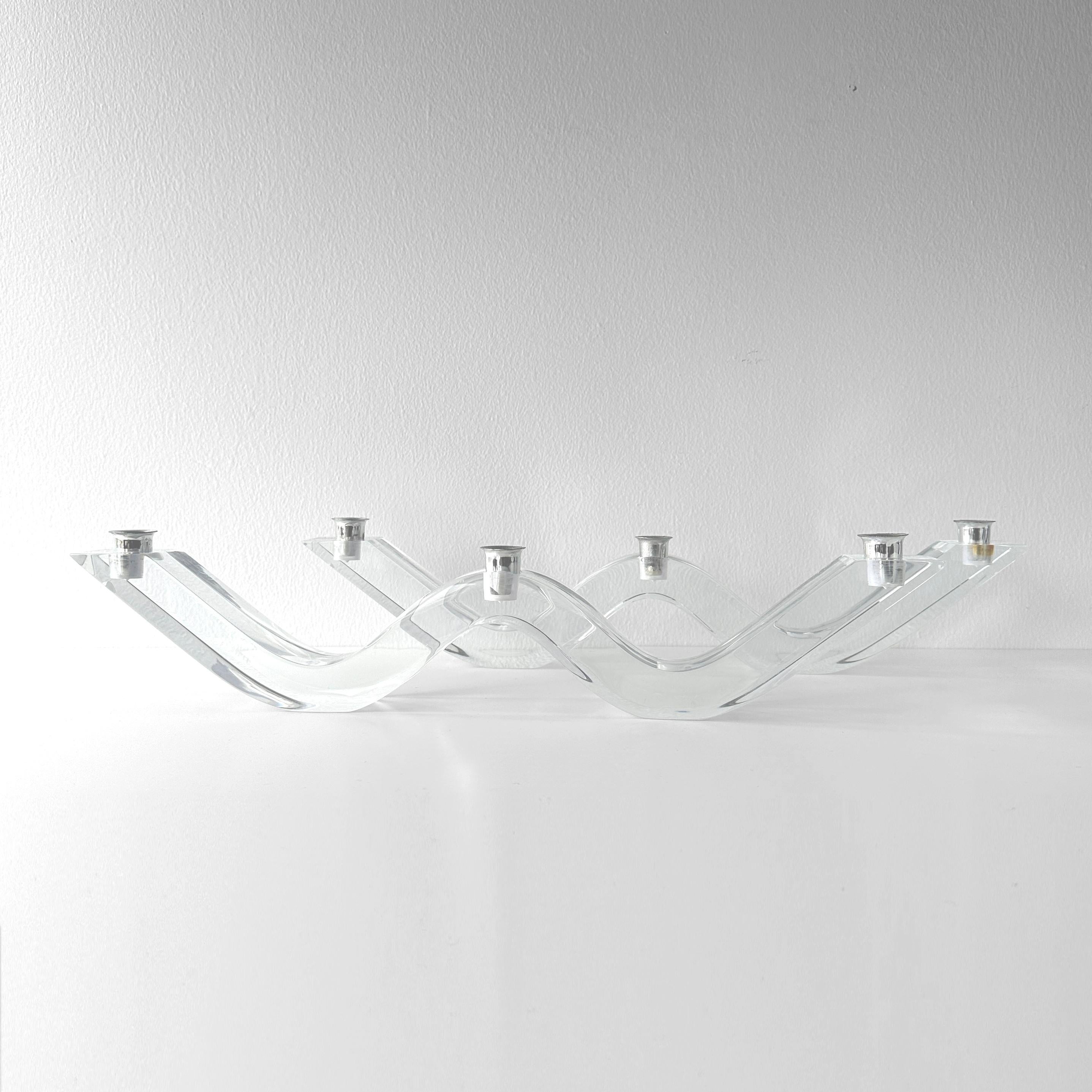 Vintage circa 1970s Astrolite candelabra pair attributed to Herb Ritts. Lucite squiggle wave design with chrome candle holders and a matching pair. Each candelabra holds 3 standard sized tapers for a total of 6. Measurements listed are for each.