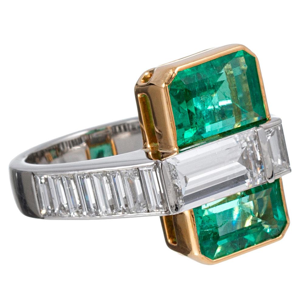 An uncommon creation, inventively designed and finished with impeccable skill, this ring is made of platinum and 18 karat yellow gold. Mid-century styling is evident, as the asymmetric design creates the appearance of an emerald swaddled by a