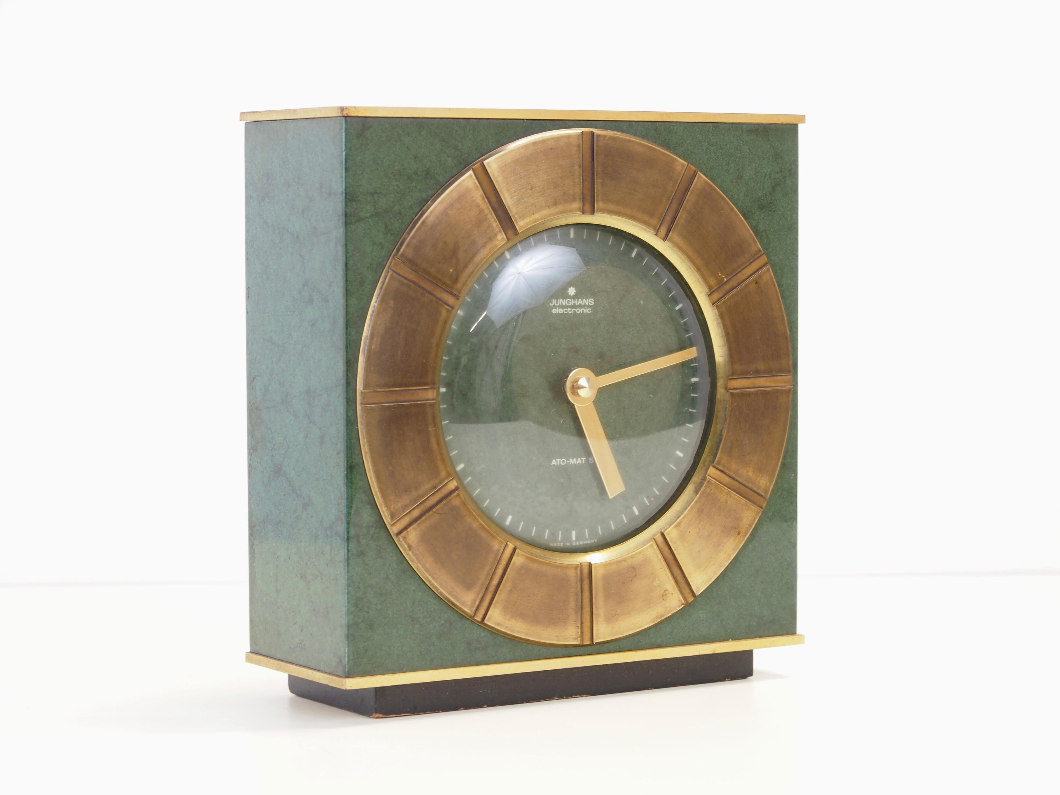 Stunning midcentury table clock made by Junghans Electronic German Clocks Manufacturer.

This rare and delicate table clock is made of solid brass green enameled plates in the 1950s or 1960s of the former century. It has a precise early electronic