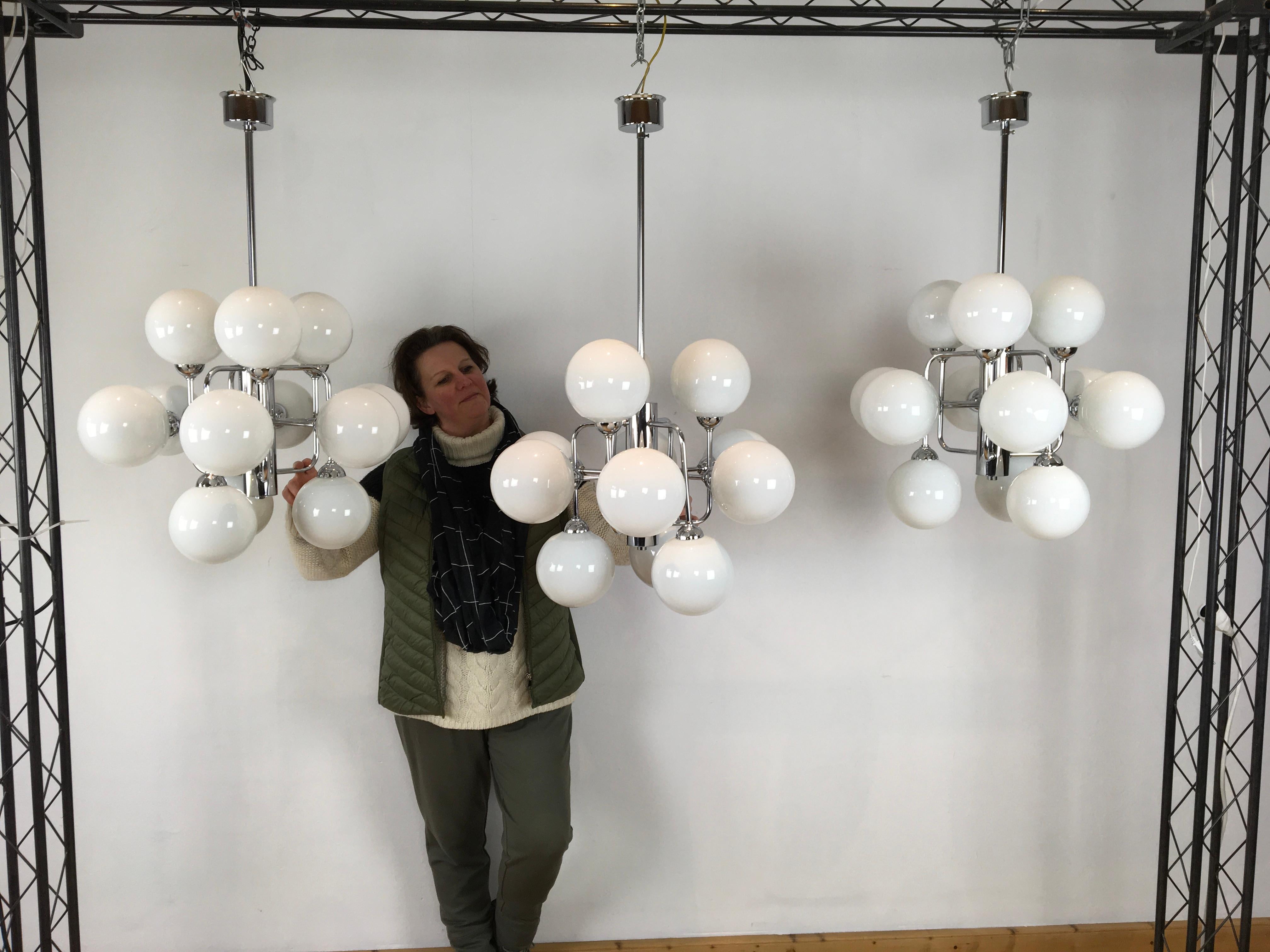 3 Midcentury atomic chandeliers with 12 handblown opaline glass globes.
12-armed molecular space age chandeliers with geometric - cubic chromed bases.
Chroom of these modern chandeliers is still in very beautiful and shiny condition.

These