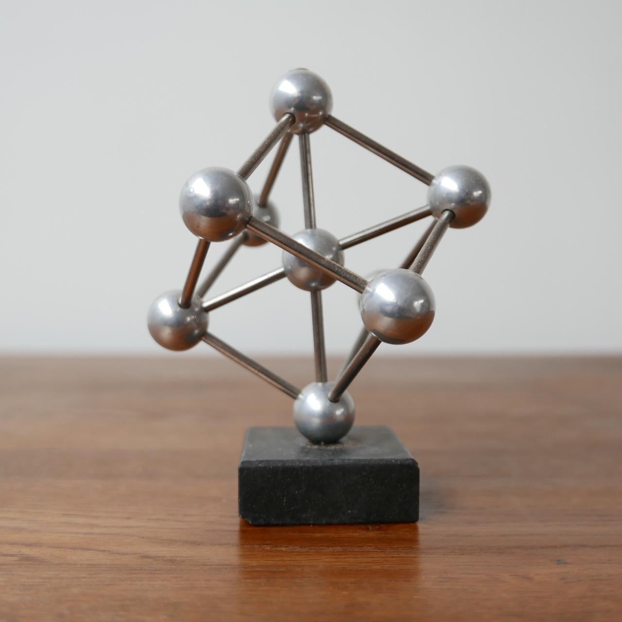 A small desk top model of the Atomium building in Brussels. 

Marble base, metal model. 

Belgium, c1970s. 

Some small nicks to the marble base, wear commensurate with age. 

Location: London Gallery. 

Dimensions: 15 H x 12 D x 15 W in