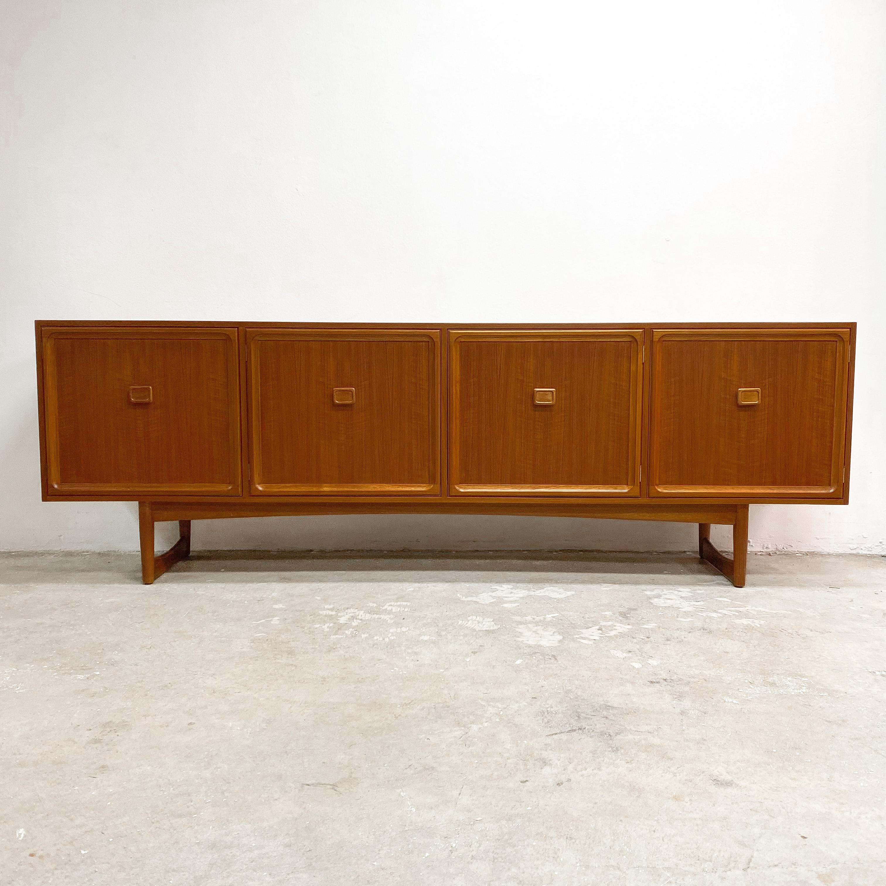 Mid century modern Australian Brand Parker teak sideboard, with square handles and sculptured sleigh legs. The extra long length offers plenty of storage. A timeless elegant piece, circa early 1970s. In great condition and has been professionally