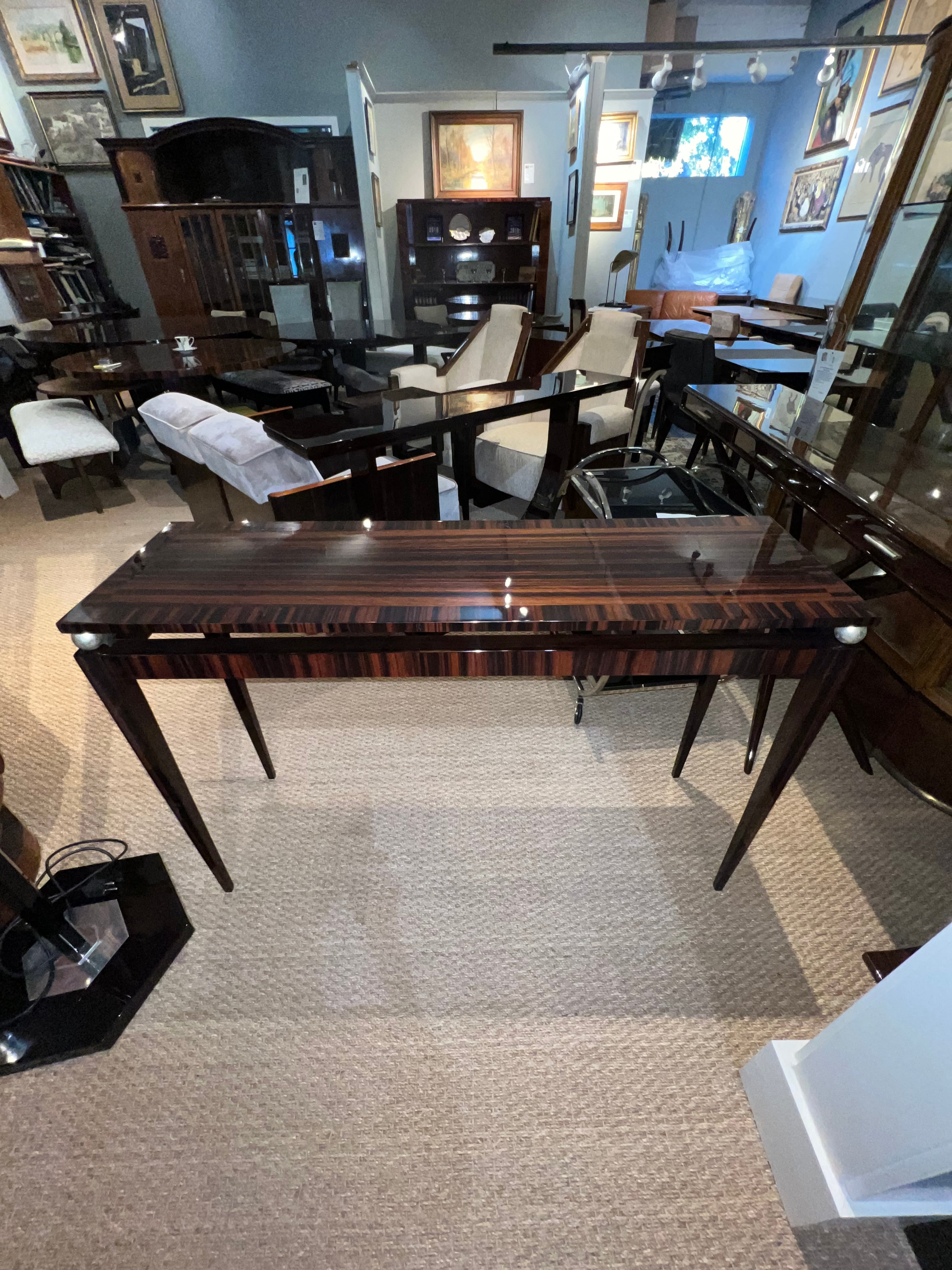 Mid-century console from Austria. Table top displays beautiful wood grain of Macassar. Top is resting on 4 elongated legs,  attached by 4 chromed spheres. 

Condition is perfect. Restored  
Austria, c. 1950s
47