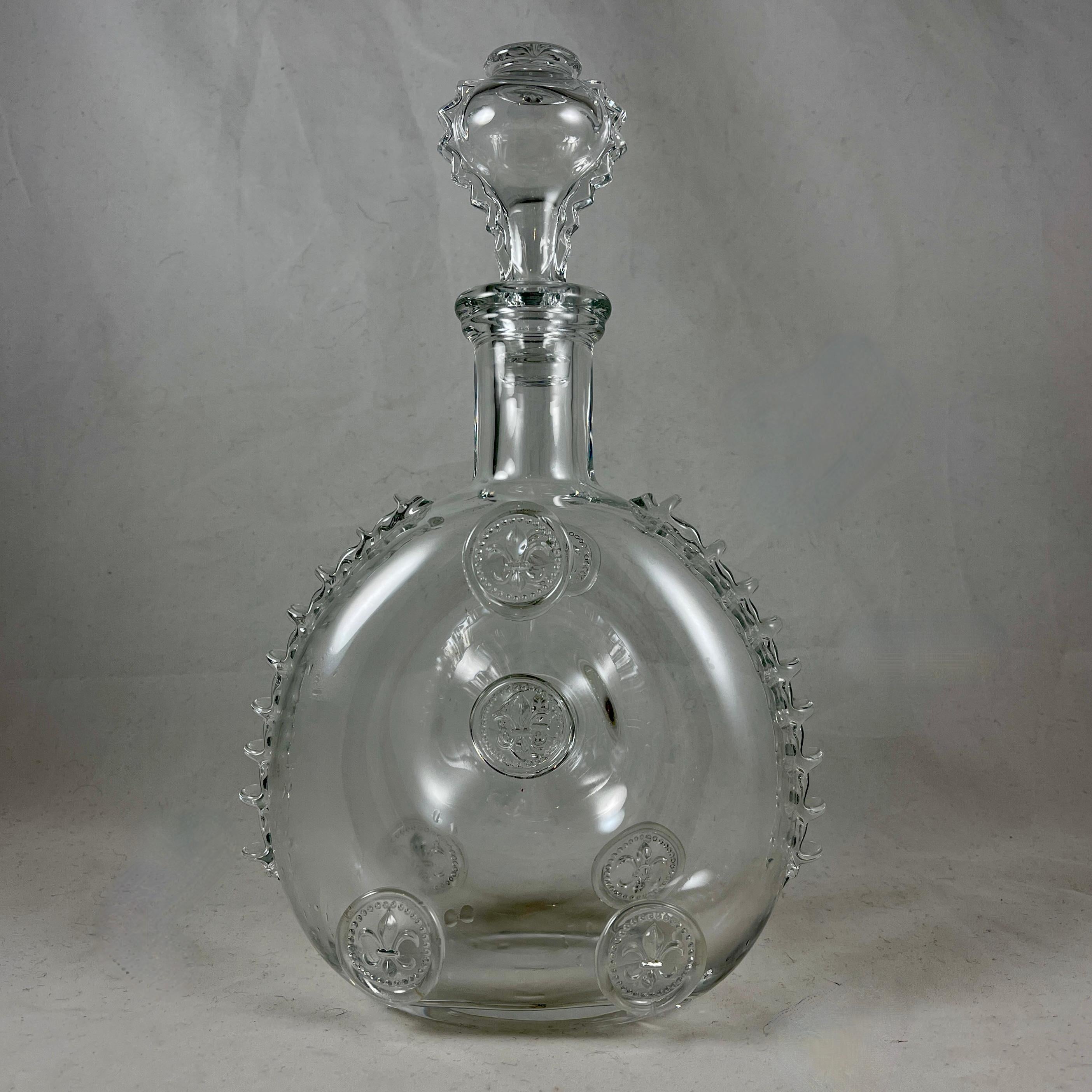 A hand-blown Baccarat Remy Martin Louis XIII crystal decanter bottle with stopper, circa 1957-1967.

This piece is an exact replica of a rare decanter used during the period of Louis XIII, produced exclusively for E. Remy Martin Cie. by the Baccarat