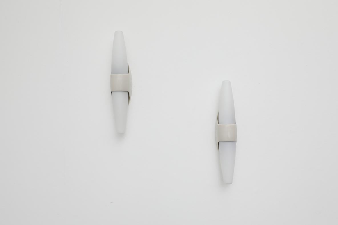 1960's double wall lamps with off-white Bakelite mount and conical, frosted glass shades. Bo-Niko was part of Niko, which to this day is still the biggest lighting company in Belgium. This particular piece is based on the work of Wilhelm Wagenfeld