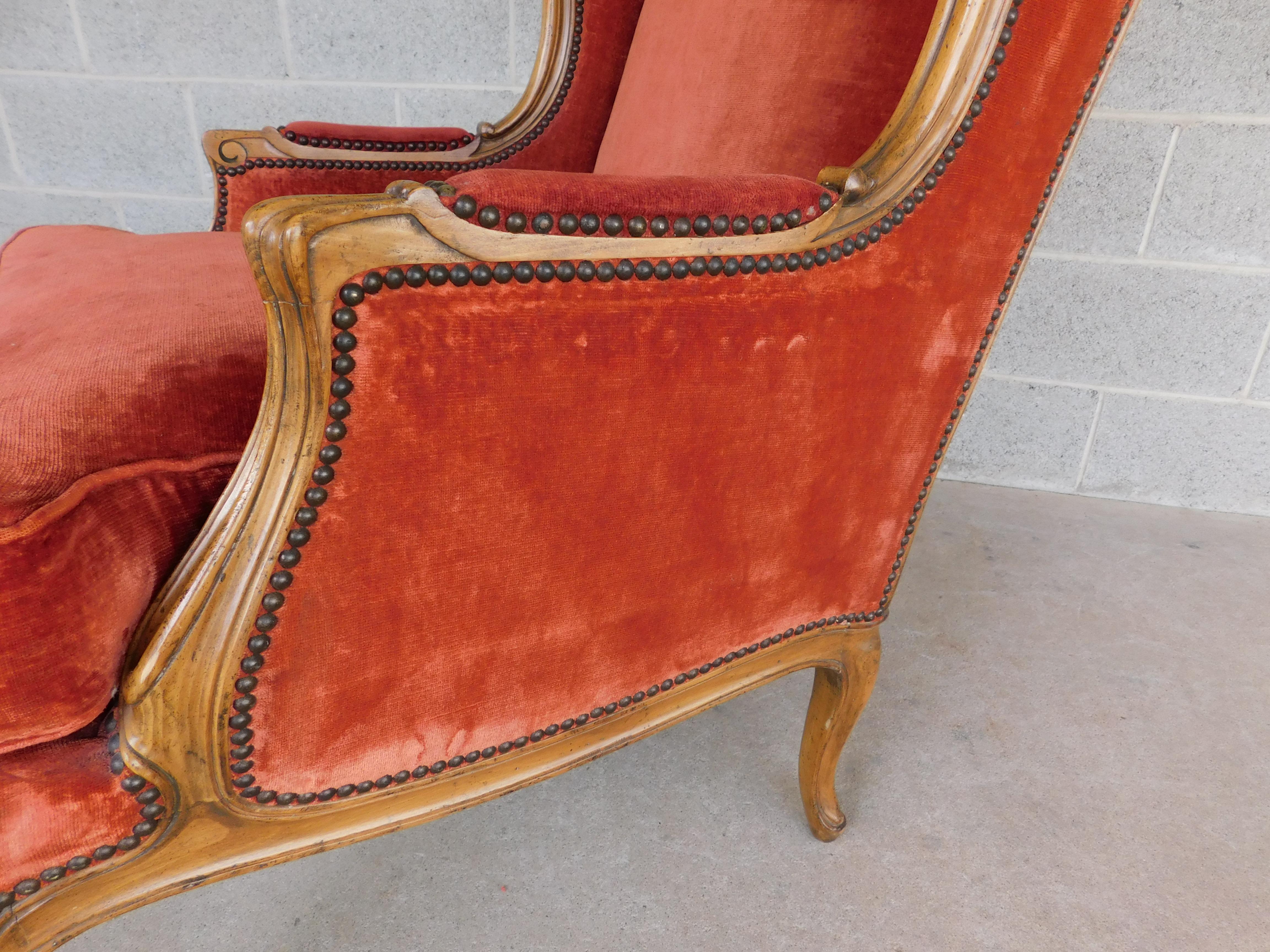 Midcentury Baker Furniture French Style Bergere chair Chanelle type upholstery. In Louis XV Style, Walnut Solid Frame, Button Tacked Surrounding original upholstery in a Rust Burnt Orange Tone. Goose and Down Feather Seat Cushion. 
Very Good