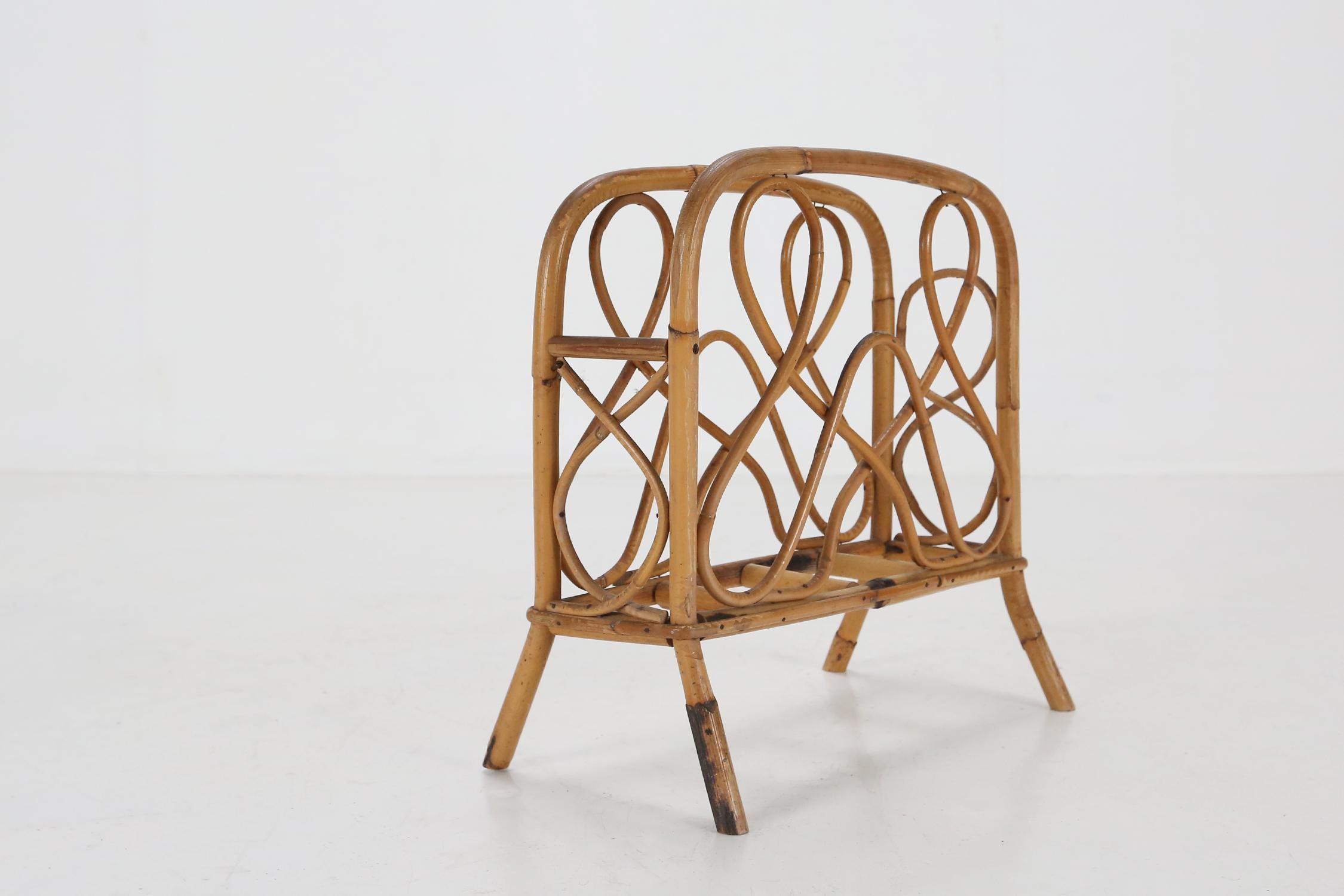 Beautiful, mid-century, bamboo and rattan magazine rack / storage basket, circa 1950's - 1960's.

Piece is of a nice size with two handles on four feet and is light, so it's not only easy to move from place to place, but extremely convenient in