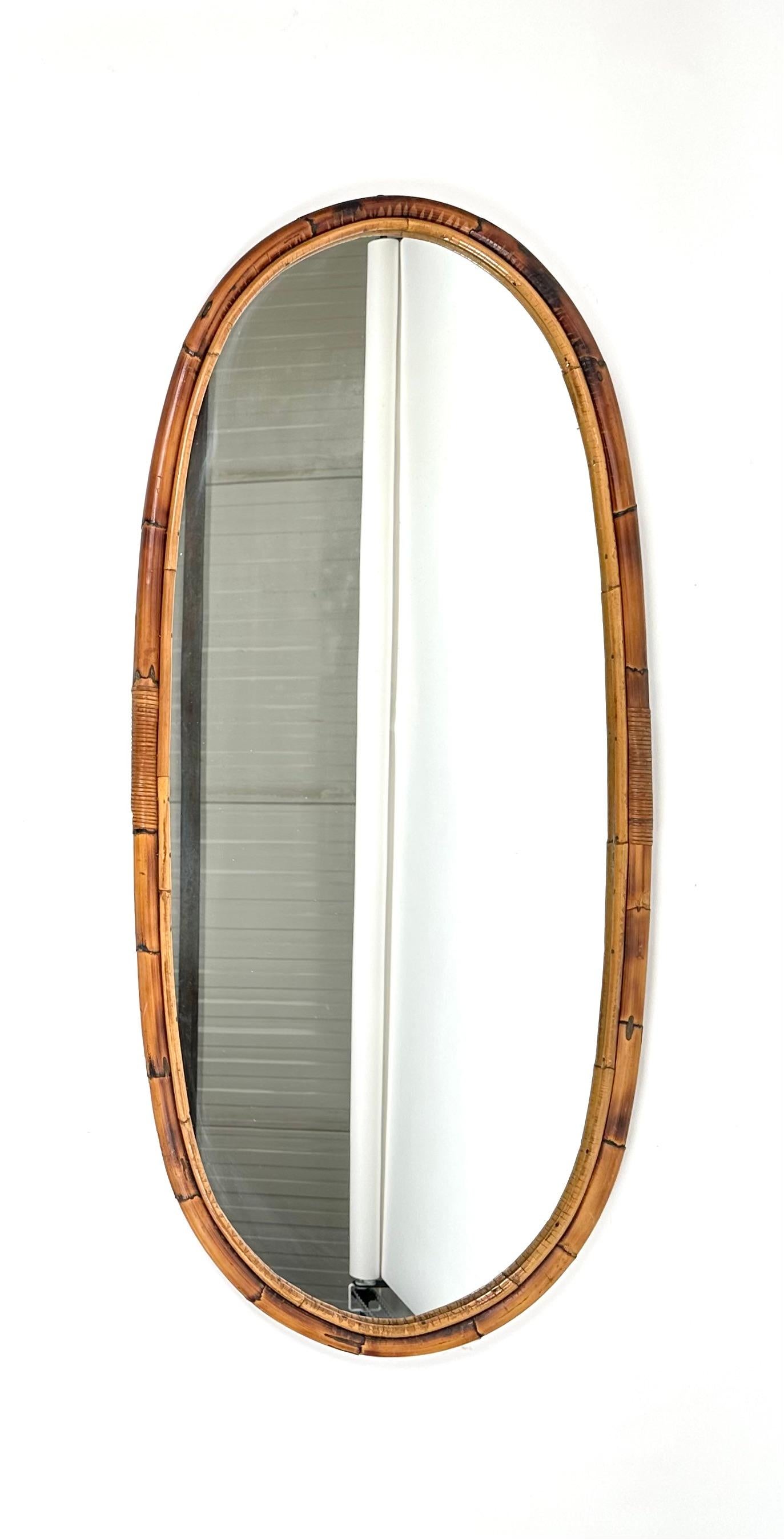 Big beautiful oval wall mirror in bamboo and rattan. 

Made in Italy in the 1960s.