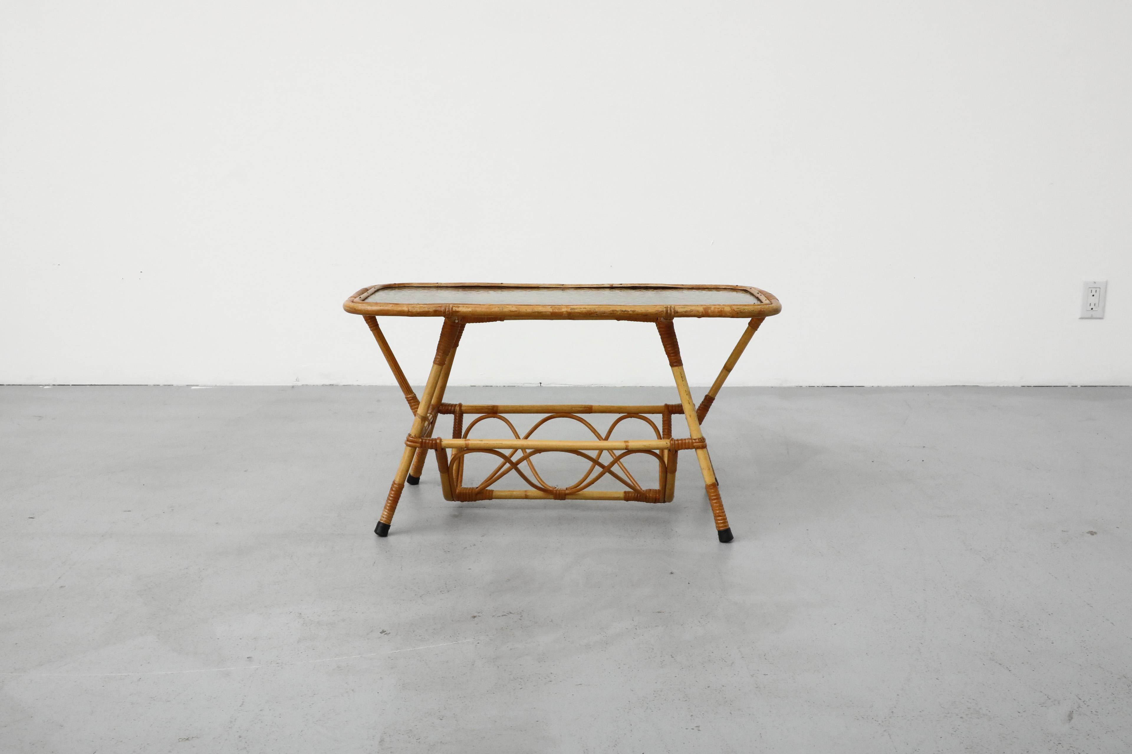 Mid-Century coffee table with bamboo frame, textured smoked glass top and curved lower basket. Designed by Dirk van Sliedregt for Rohe Noordwolde. Lower basket measures 18.25