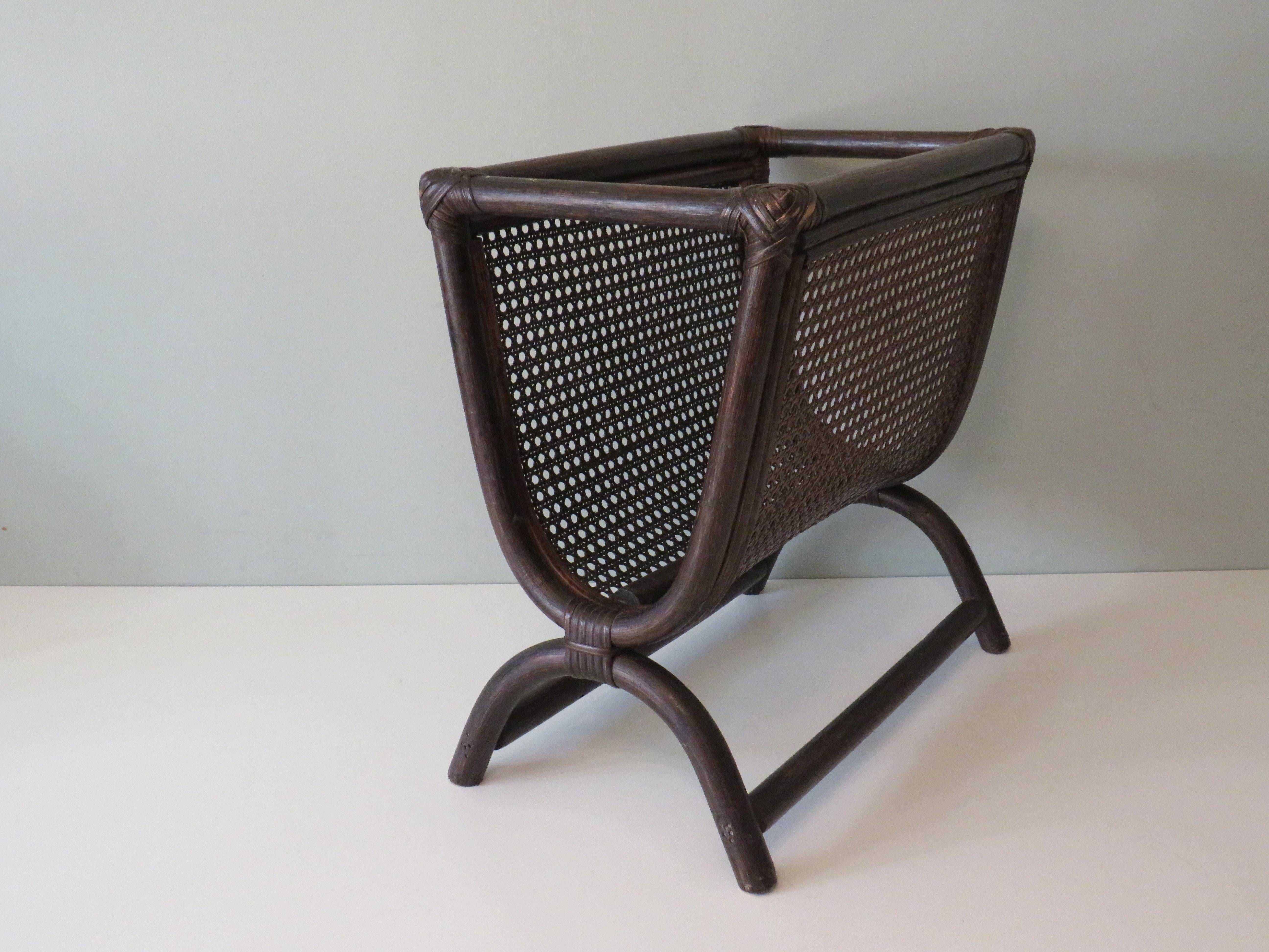 Stylish magazine rack made of dark stained bamboo with webbing panels.
The item has minor signs of wear on the corners, which are due to its age.