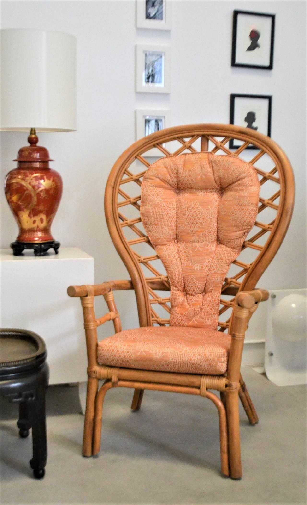 Striking midcentury sculptural bent bamboo fan back armchair, circa 1960s-1970s. This decorative peacock occasional chair is designed with an upholstered seat and tufted back cushion and accented with an intricately woven rattan back.
Measures: 49