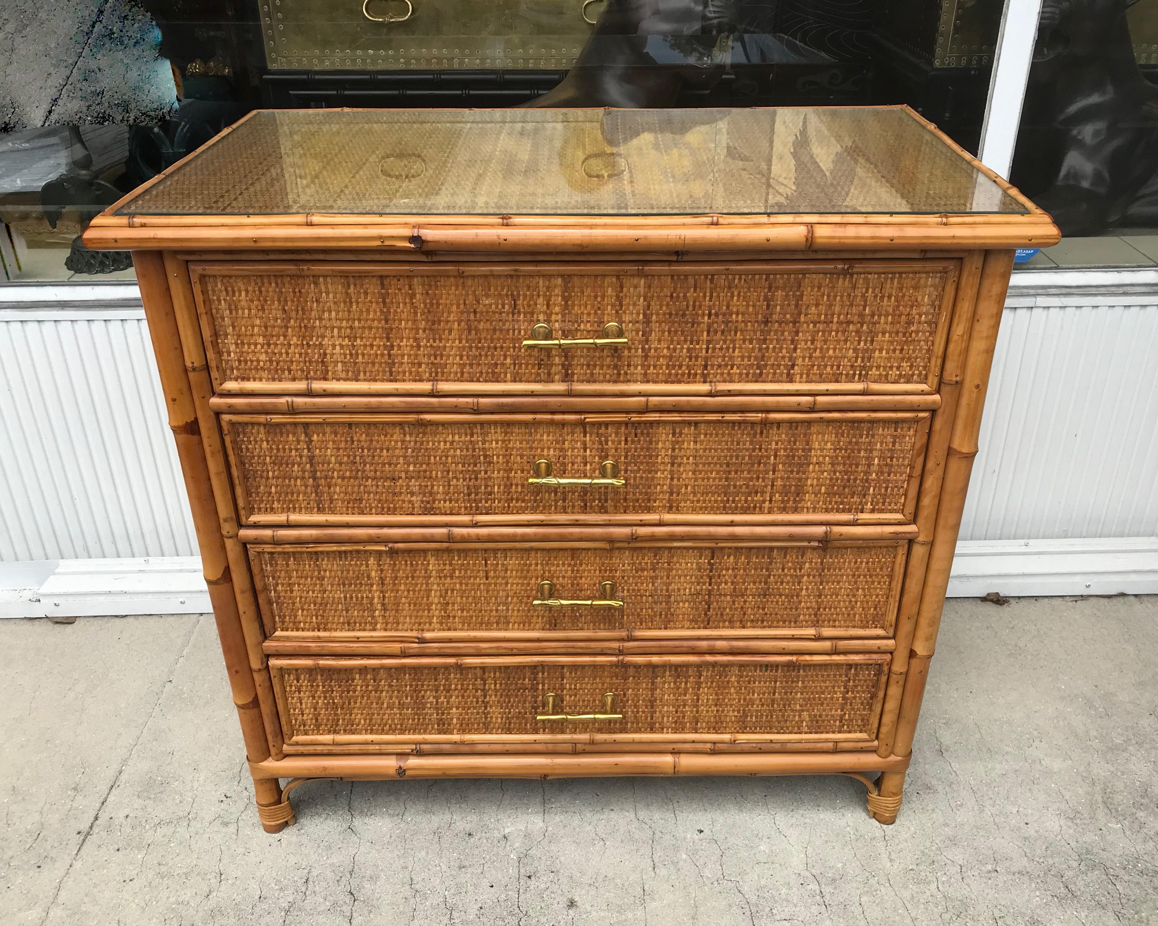 Superb quality. The piece is finished on all four sides-inset with grass
cloth. 
Bamboo trim is prominent all around. Additionally, the dresser is accented
with bamboo like handles fashioned in brass. A superb example.
( the top has a removable
