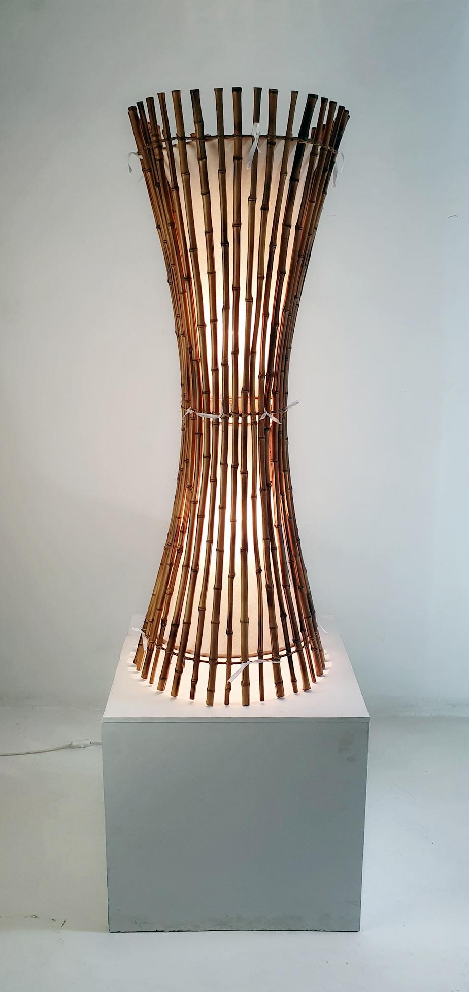 A mid century floor lamp produced around the 1960's in the manner of Franco Albini in Italy. The lamp is very light yet it is sturdy and stands stabile on the ground. The bamboo is in excellent condition and the fabric inside has been restored. The