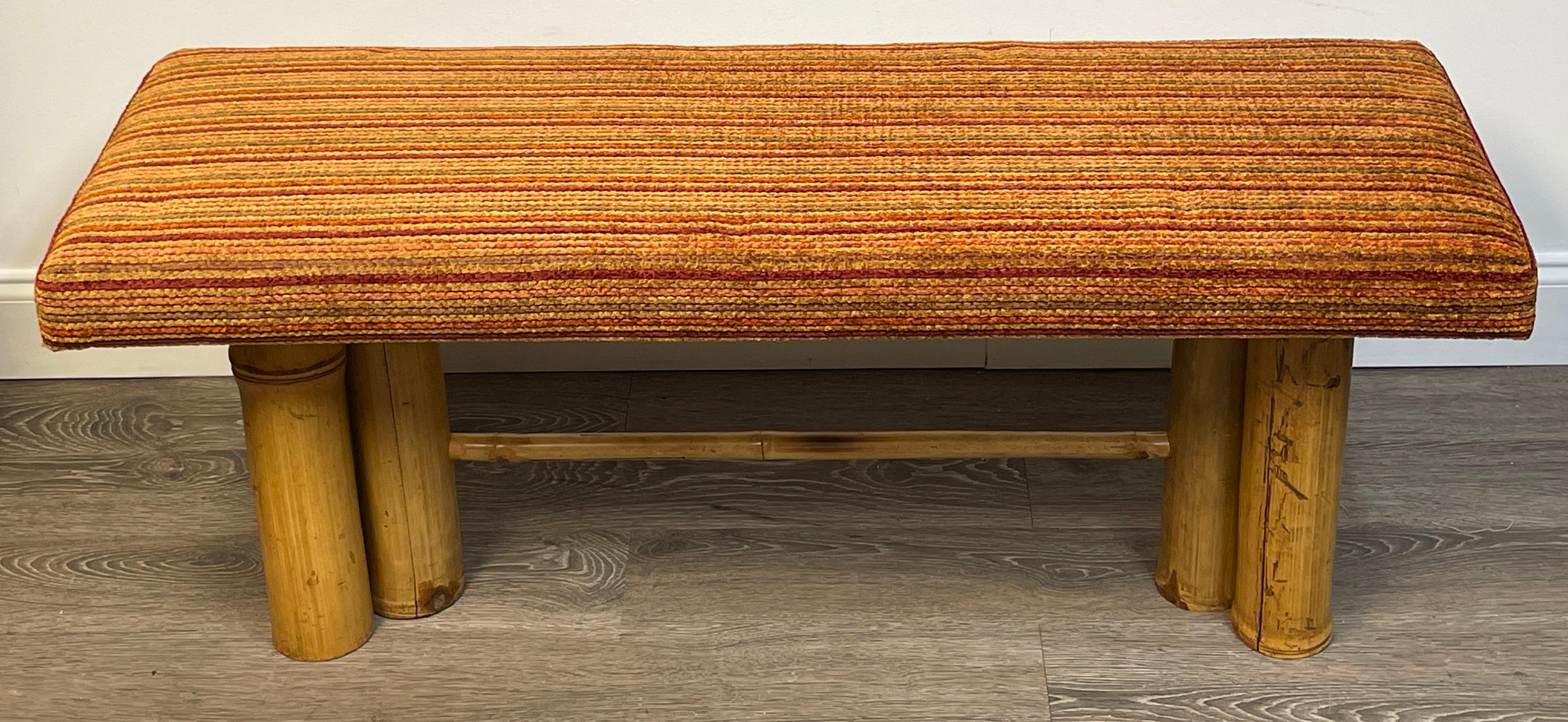 Mid century bamboo long bench.
A well proportioned ready to place bench for your consideration. 
Of rectangular form with recent marigold color palette horizontal stripped chenille cotton blend upholstery.
Raised on on six large real bamboo legs