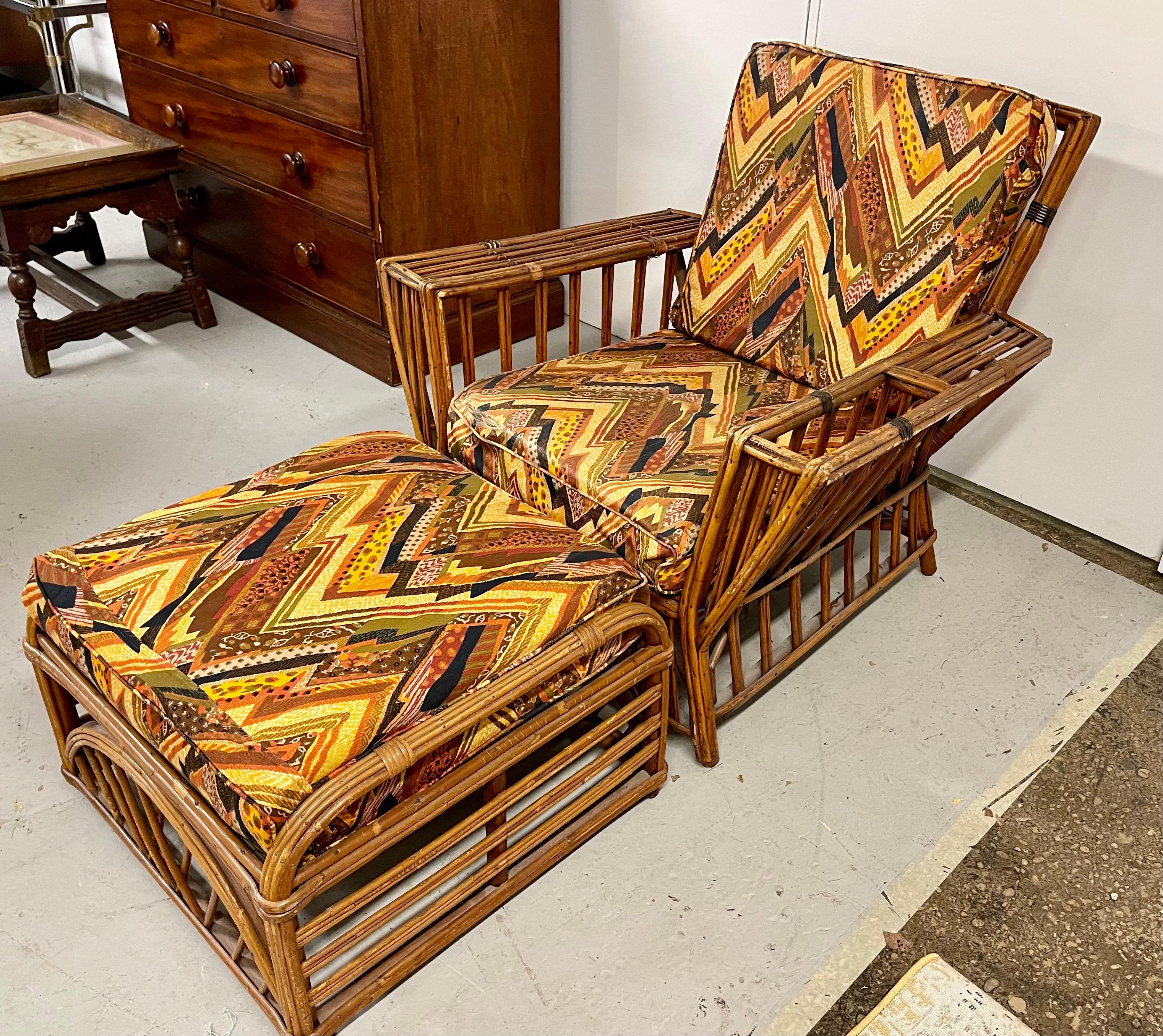 Vintage mid-century bamboo and wicker lounge chair and with matching ottoman and what appears to be original Jack Lenor Larsen fabric. Yet, what really set this piece apart, is the built-in magazine rack on the right facing arm. Own the best!