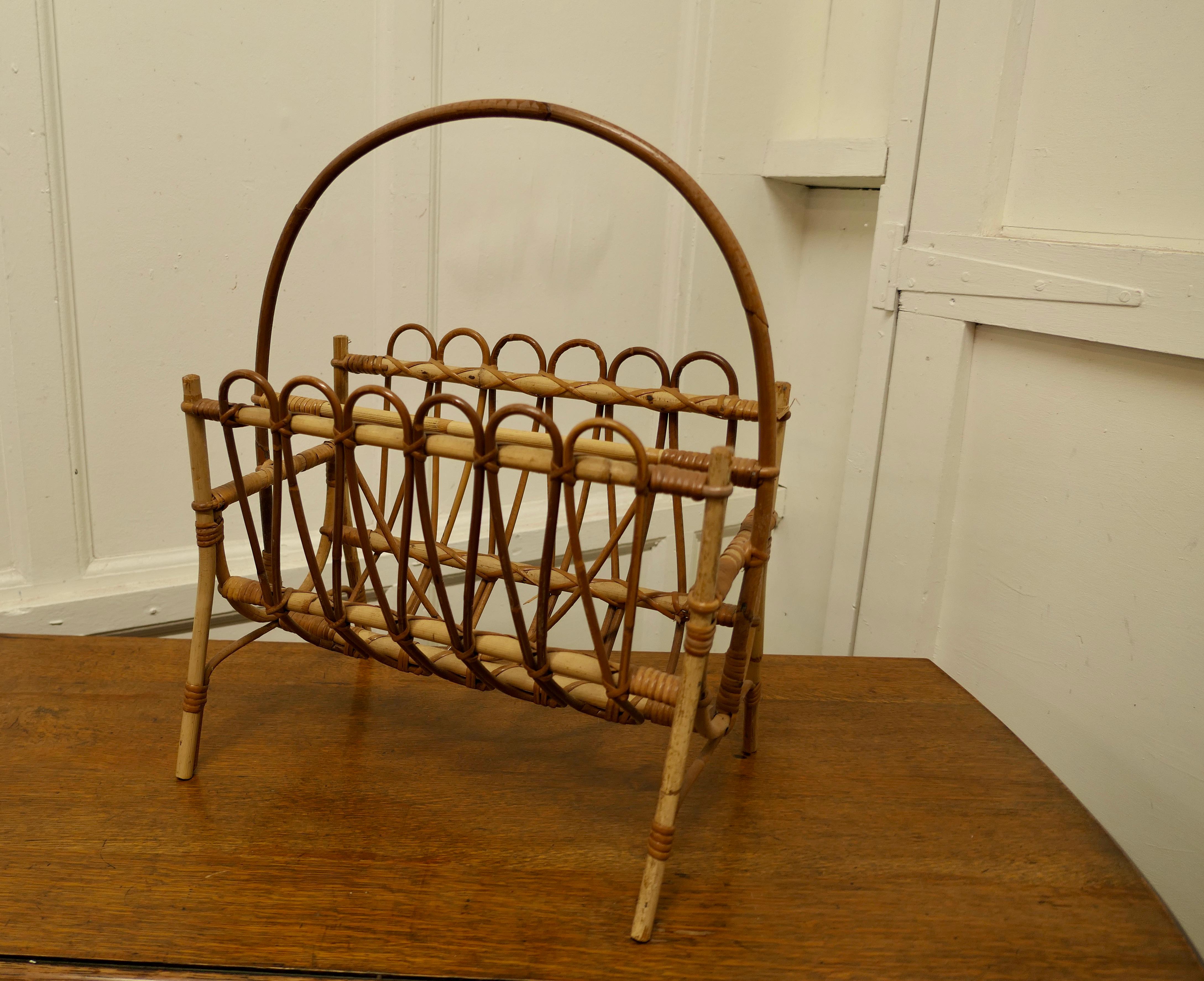 Mid Century Bamboo Magazine Rack

This is a real retro piece, made in bamboo, it has 2 magazine sections and it stands on neat legs and has a hoop-over handle 
An excellent and good stylish looking piece and it is in good sound condition  
The Stand