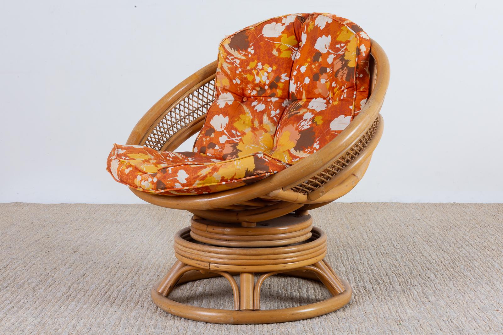 Unique Mid-Century Modern bamboo rattan swivel lounge chair. Features a round seat and base made of steam bent rattan. The sides are decorated with an open fretwork design with an open fretwork design the chair also has a rocking mechanism.