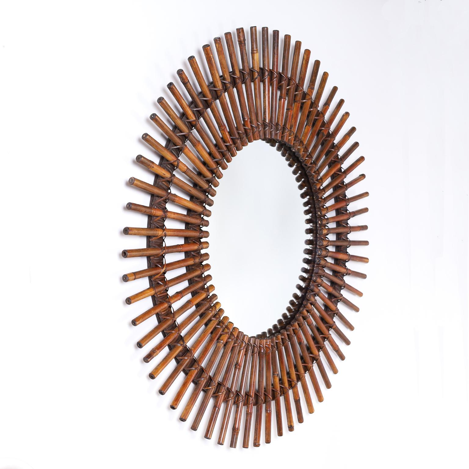 Colonial style wall mirror with bamboo sun rays affixed with wrapped reed emanating around a circular looking glass.





 