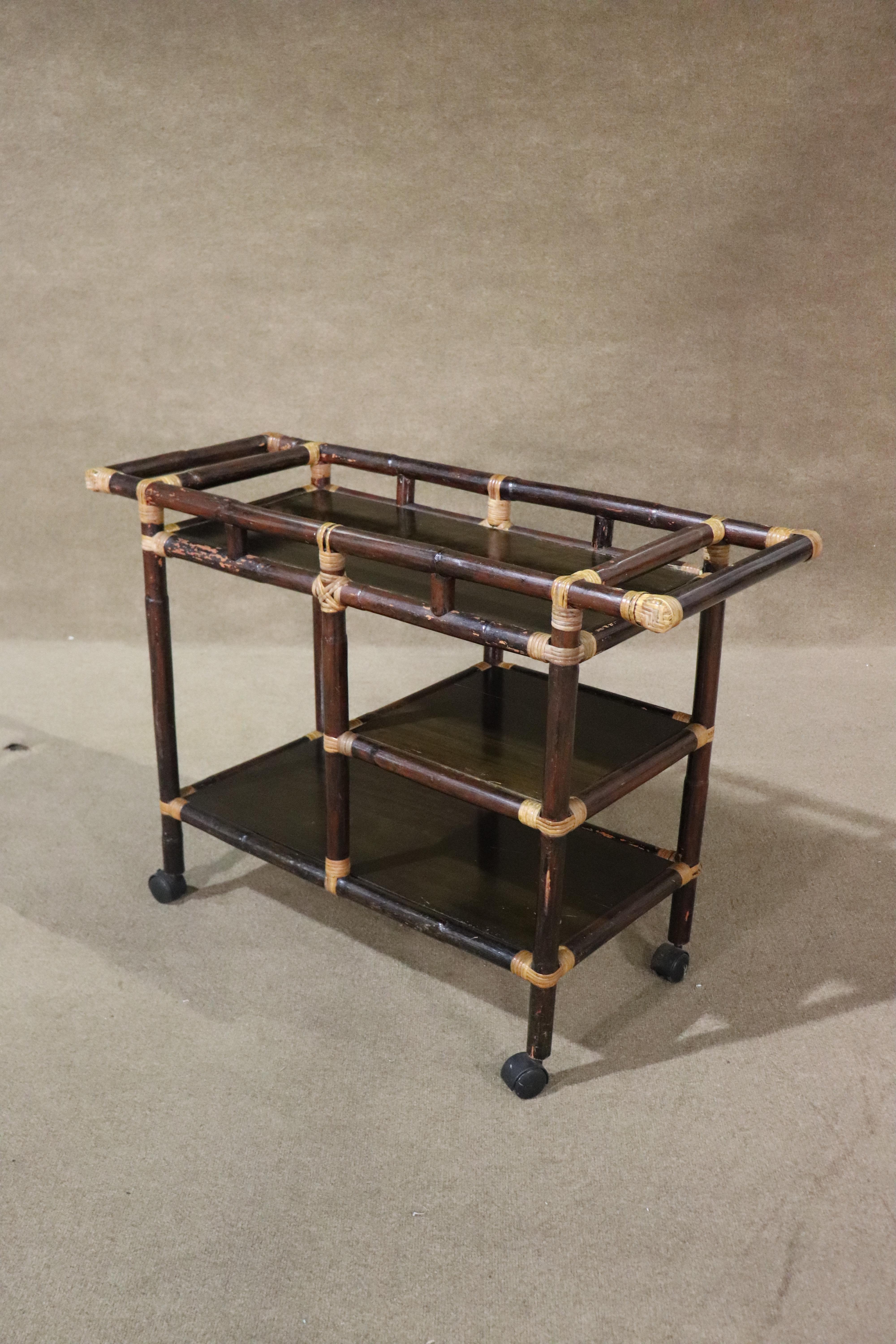 This rustic style rolling cart is ready for entertaining! Dark bamboo frame with accenting rattan finishes. Three shelves for your beverages and accessories.
Please confirm location NY or NJ