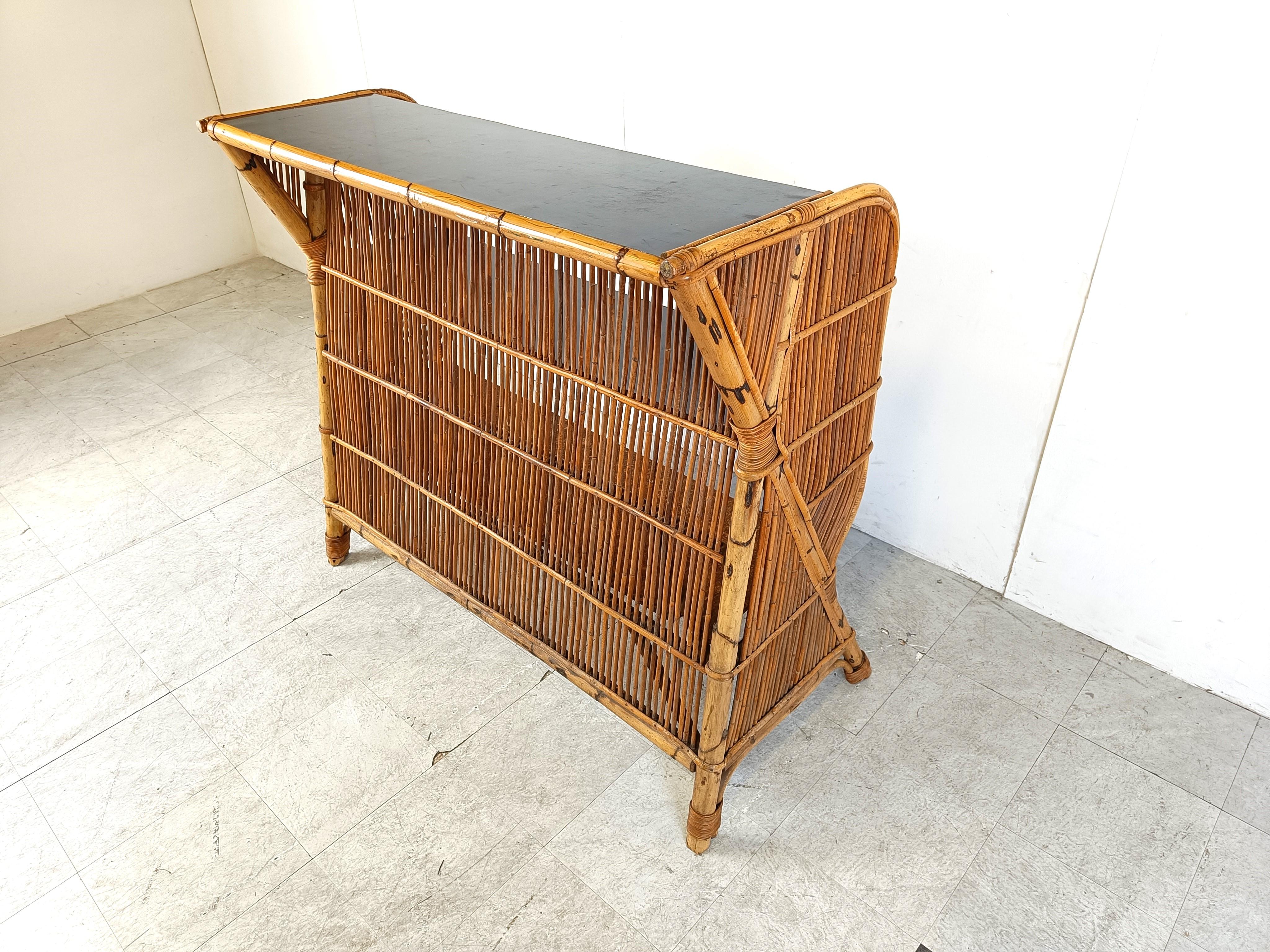 Lovely Tiki bar in bamboo for sale with a black formica table top and beautiful reeded bamboo frame.

Beautiful and well made example.

Very good condition.

1960s - France

Dimensions:
Height: 115cm/45.27