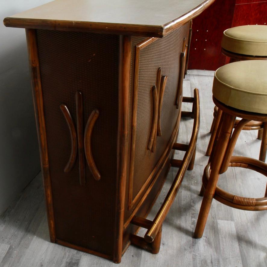 A clean survivor from a 70s basement, ready to move on up and entertain in a more modern family room. Sturdy and well made from thick hardwood with a bamboo veneer, there's plenty of room to store bottles and barware. Its top is vintage Formica. The