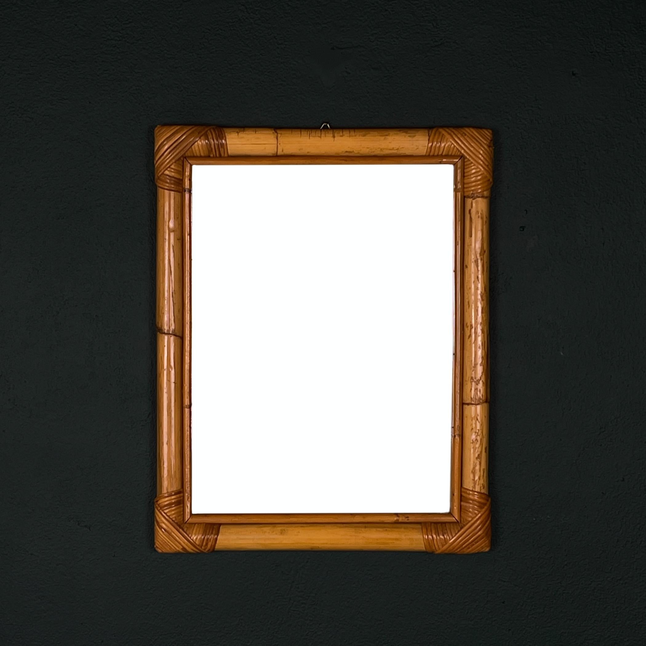 Mid-century bamboo wall mirror made in Italy in the 1960s.

The vintage mirror is in very good vintage condition, with no damage. The glass is original.

Dimensions:
Width: 40 cm / 15.75 inches
Height: 50 cm / 19.7 inches
Depth: 4 cm / 1.57