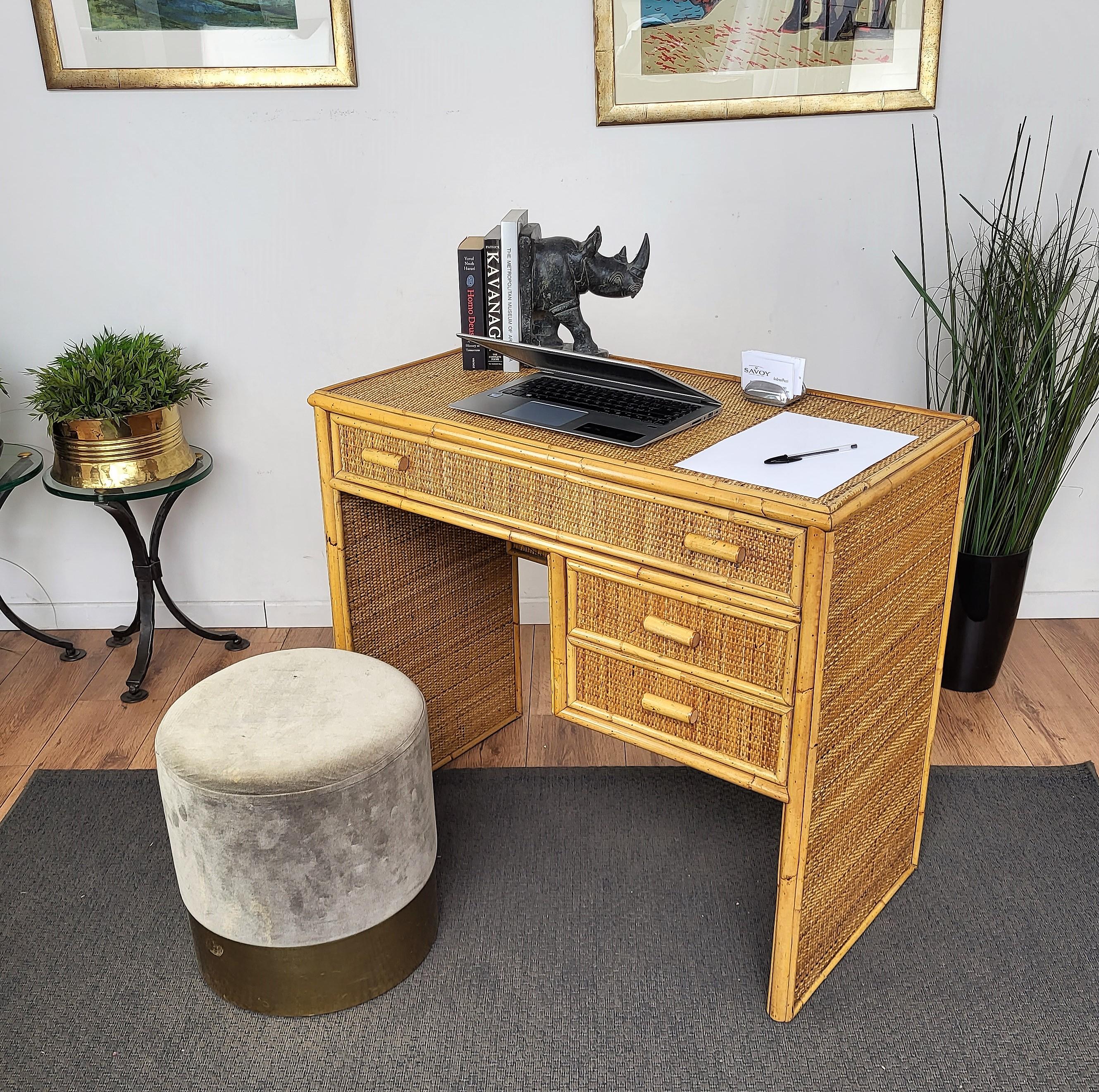Beautiful 1970s Italian Mid-Century Modern bamboo and wicker desk with three drawers, a large one and two small ones, finished on 4 sides making it perfect as stand alone or against a wall.
 
This charming piece is in the typical style of Audoux