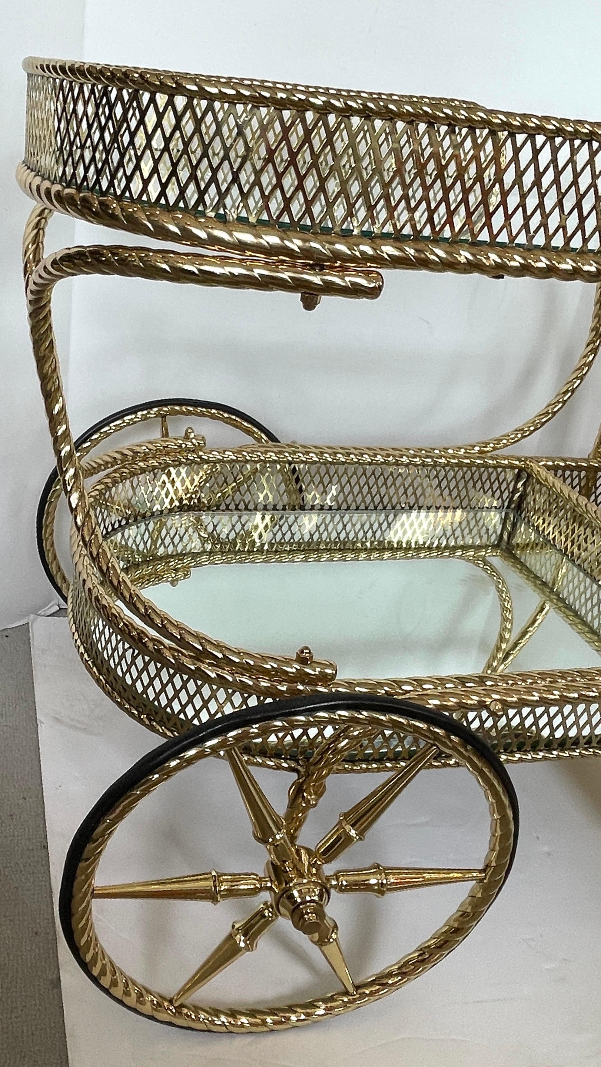 This is a fabulous and rare Italian Bar Cart  in polished solid Brass with a  Rope Design throughout .
There are two shelved one,  the top shelf is see through,  the bottom shelf is mirrored.
There is also a Brass Basket container for bottles.
This