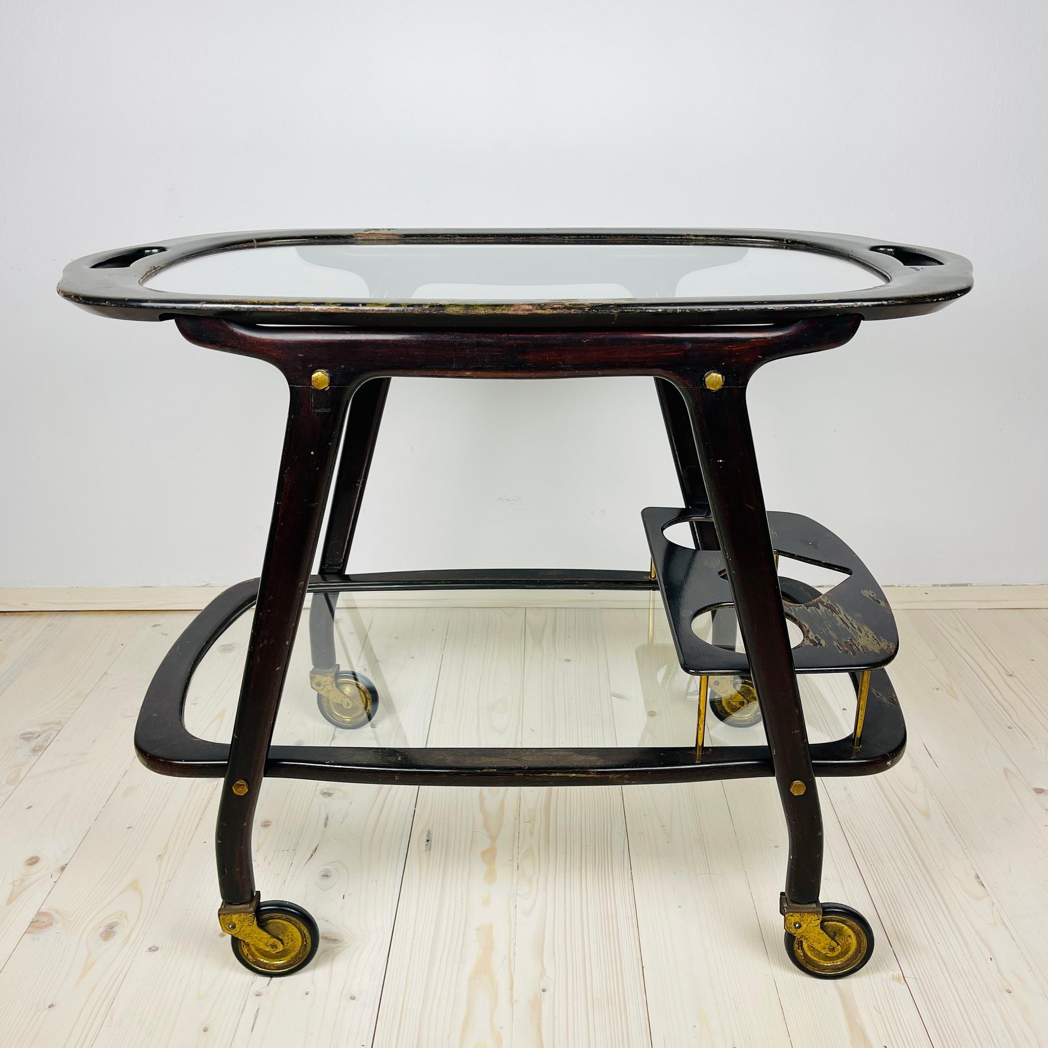 Wonderful Italian wooden trolley with glass and brass finishes. It has a removable serving tray. This item is by Italian designer Ico Parisi for De Baggis in the 1960s, has wonderful rounded lines. Ico Parisi is a talented Italian designer. His