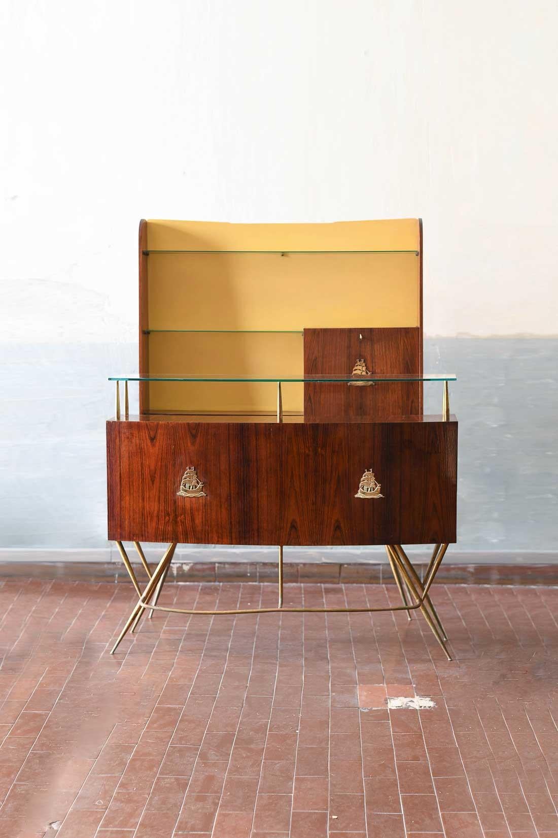 Mid-Century Bar Counter in wood, brass and glass. Italian artisan production.
The set consists of 1 Counter unit with shelves + 1 bottle rack with shelves and folding door.
Dimensions:
Counter: 137 L x 109 H x 50 D cm
Bottle holder: 123 L x 175 H x