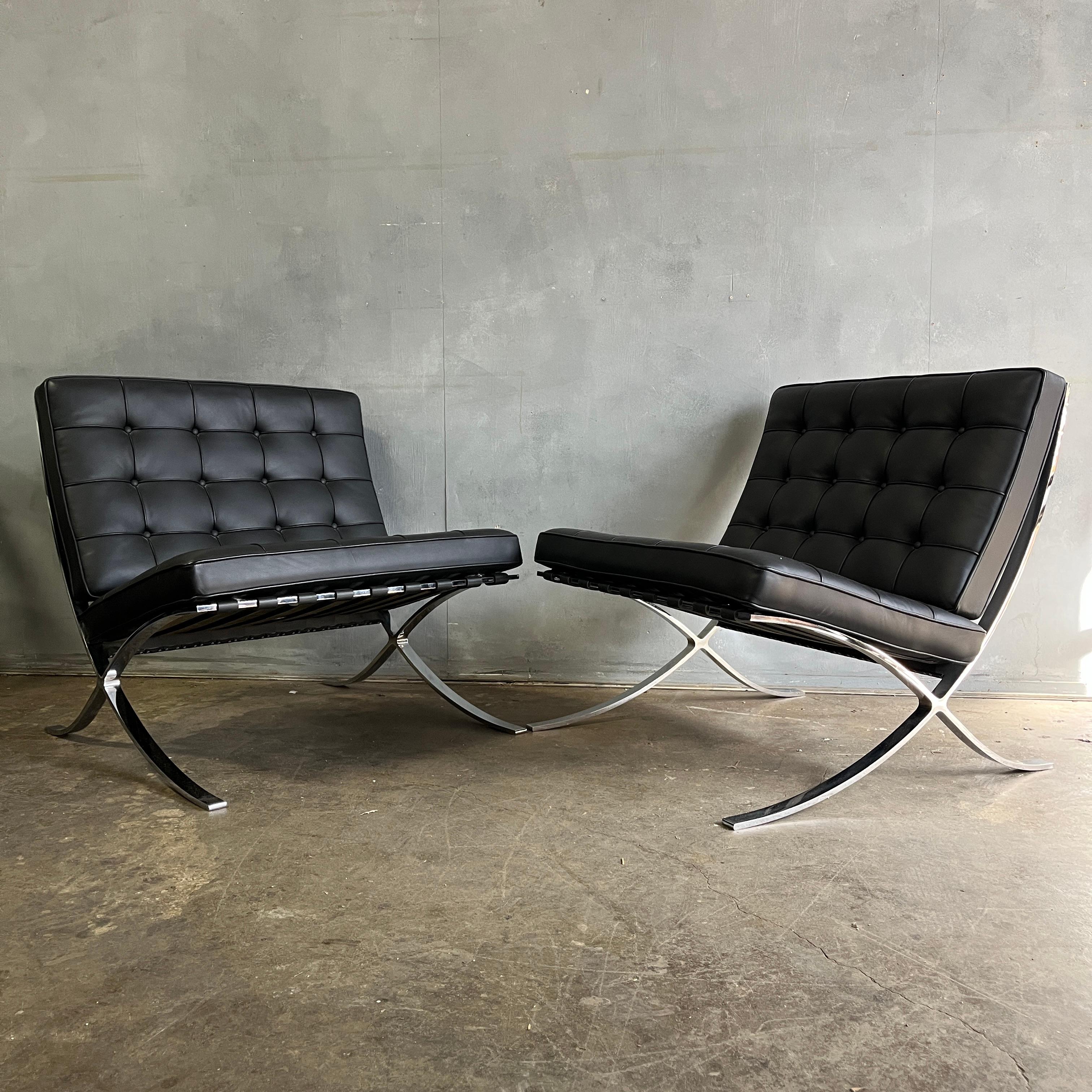 Pair of Barcelona lounge chairs by Ludwig Mies van der Rohe for Knoll in black leather. The frame is stamped KnollStudio / Mies van der Rohe and the cushions are also labeled Knoll. In wonderful near perfect condition showing minimal use. Lounge