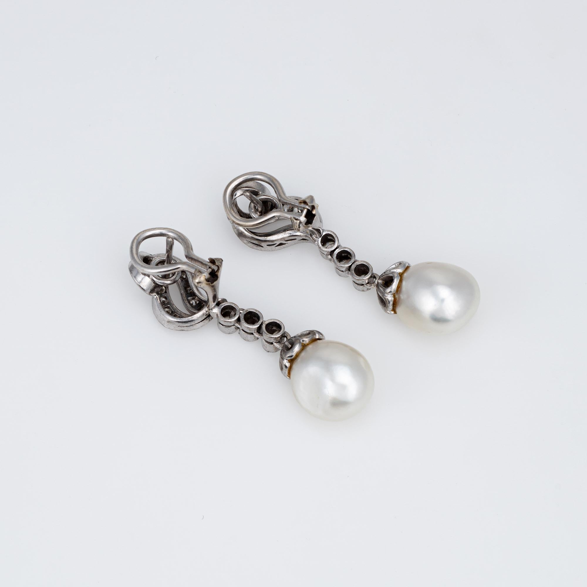 Elegant pair of vintage diamond & baroque pearl earrings crafted in 14k white gold (circa 1950s to 1960s). 

Round brilliant diamonds total an estimated 0.50 carats (estimated at H-I color and VS2-SI2 clarity). The pearls measure 10.5mm each.  

The