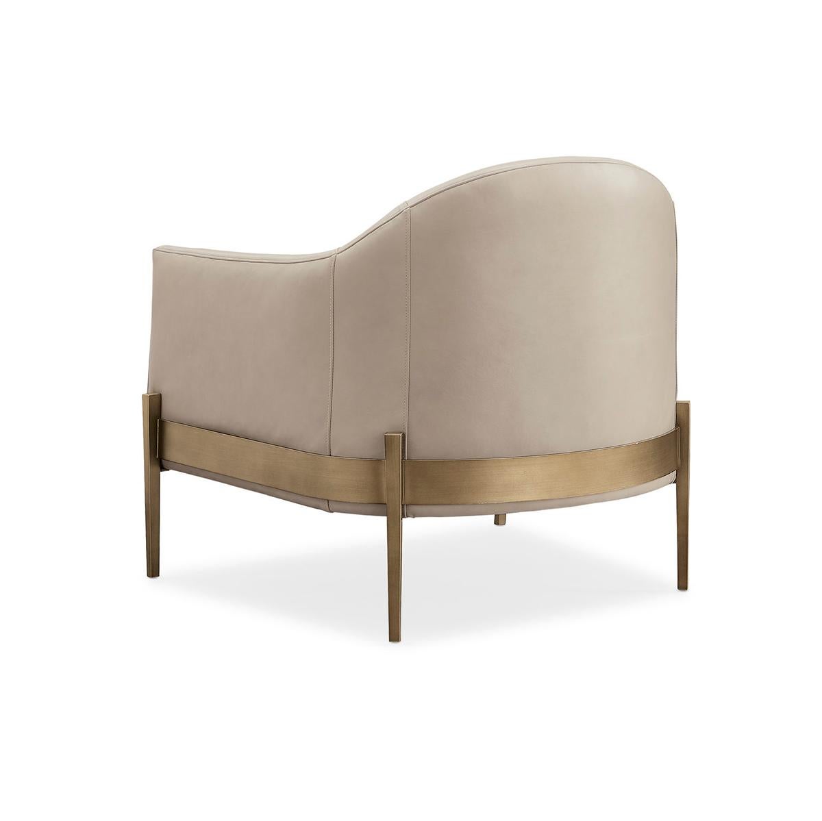 This exquisite piece combines classic design with contemporary flair, making it a standout addition to any room.

Upholstered in luxurious taupe leather, it offers both comfort and sophistication. The chair’s generously scaled silhouette is