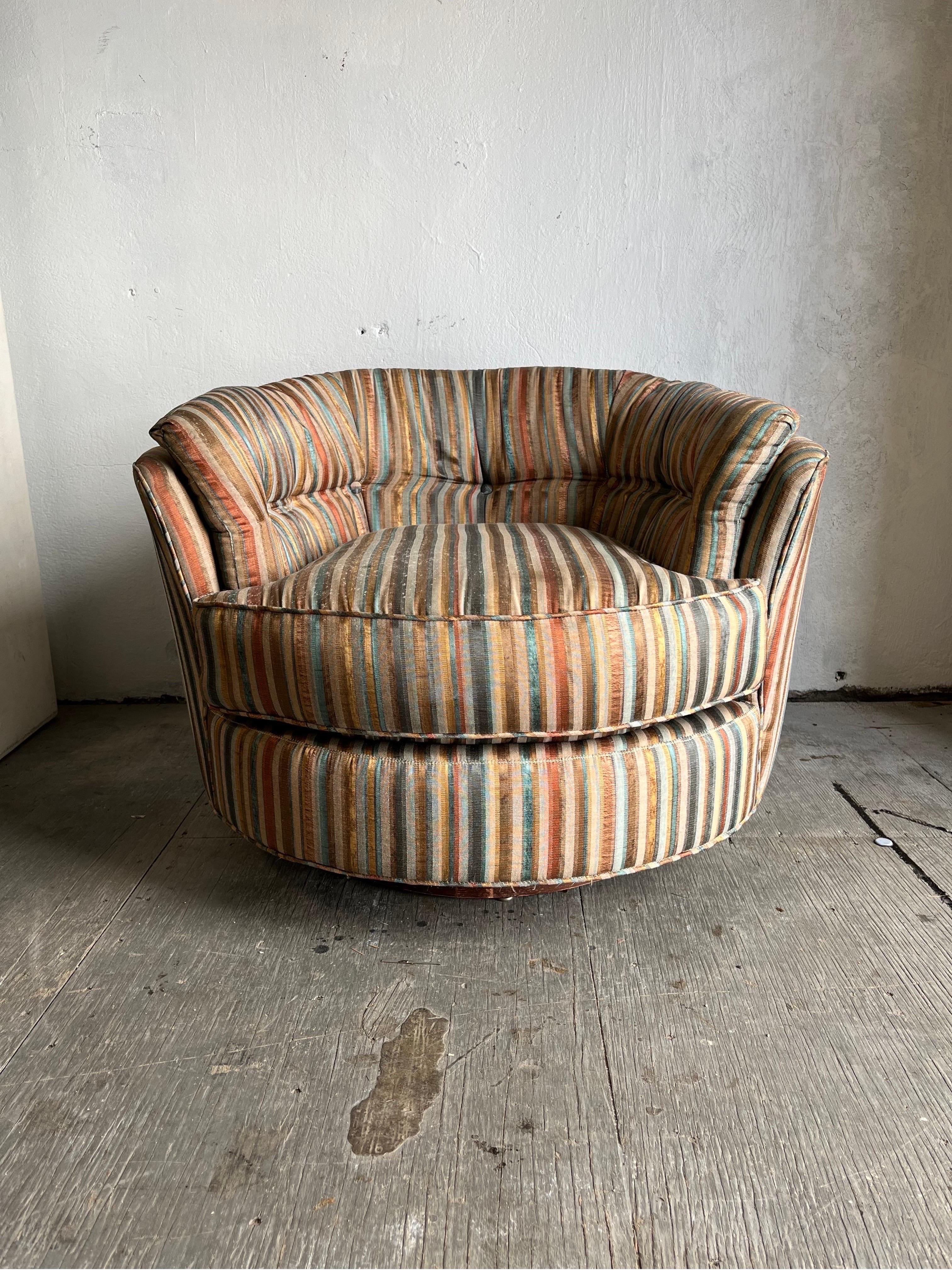 Great Barrel Swivel Club Chair in the manner of Milo Baughman. Striped upholstery in period colors. Plush cushions and sits on a wood base. 
Curbside to NYC/Philly $350
