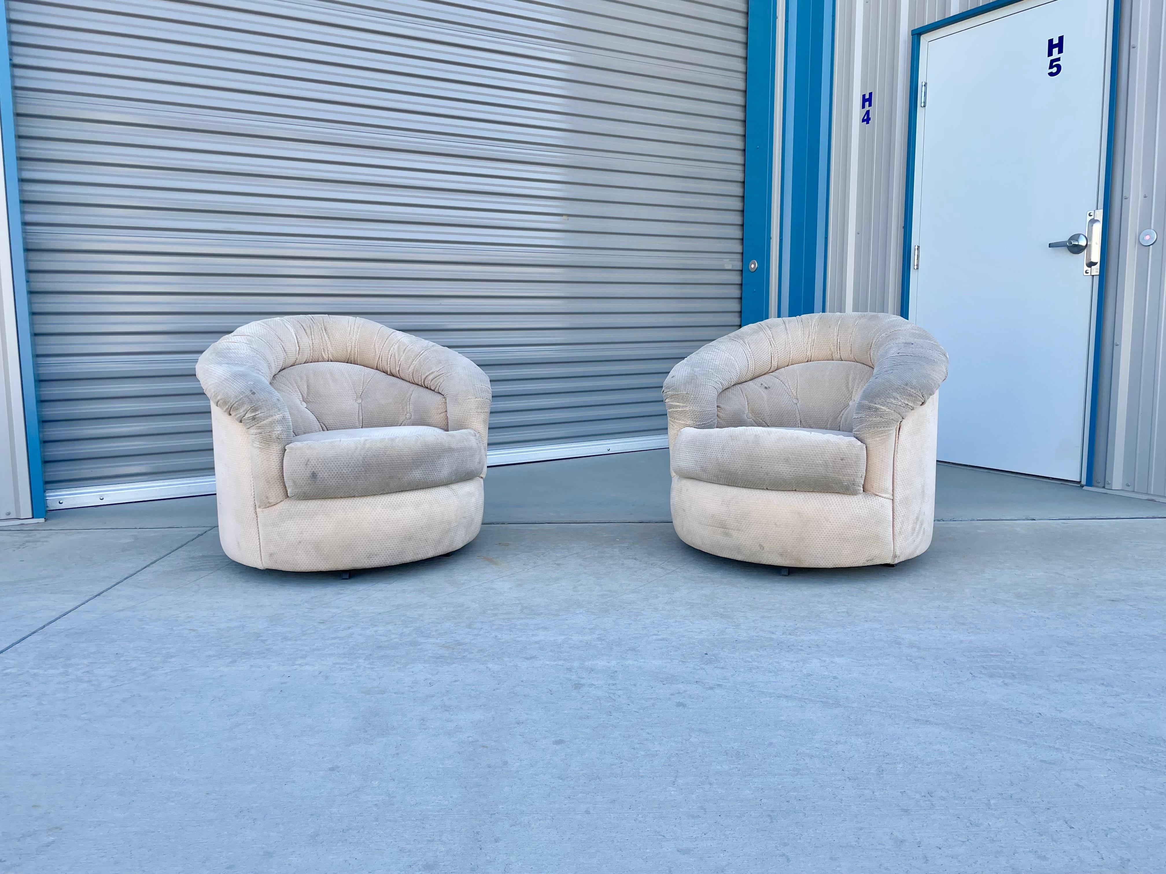Fantastic vintage pair of barrel chairs styled after Milo Baughman was designed and manufactured in the United States circa 1970s. These beautiful chairs feature a swivel base that rotates 360 degrees. These swivel chairs are guaranteed to draw