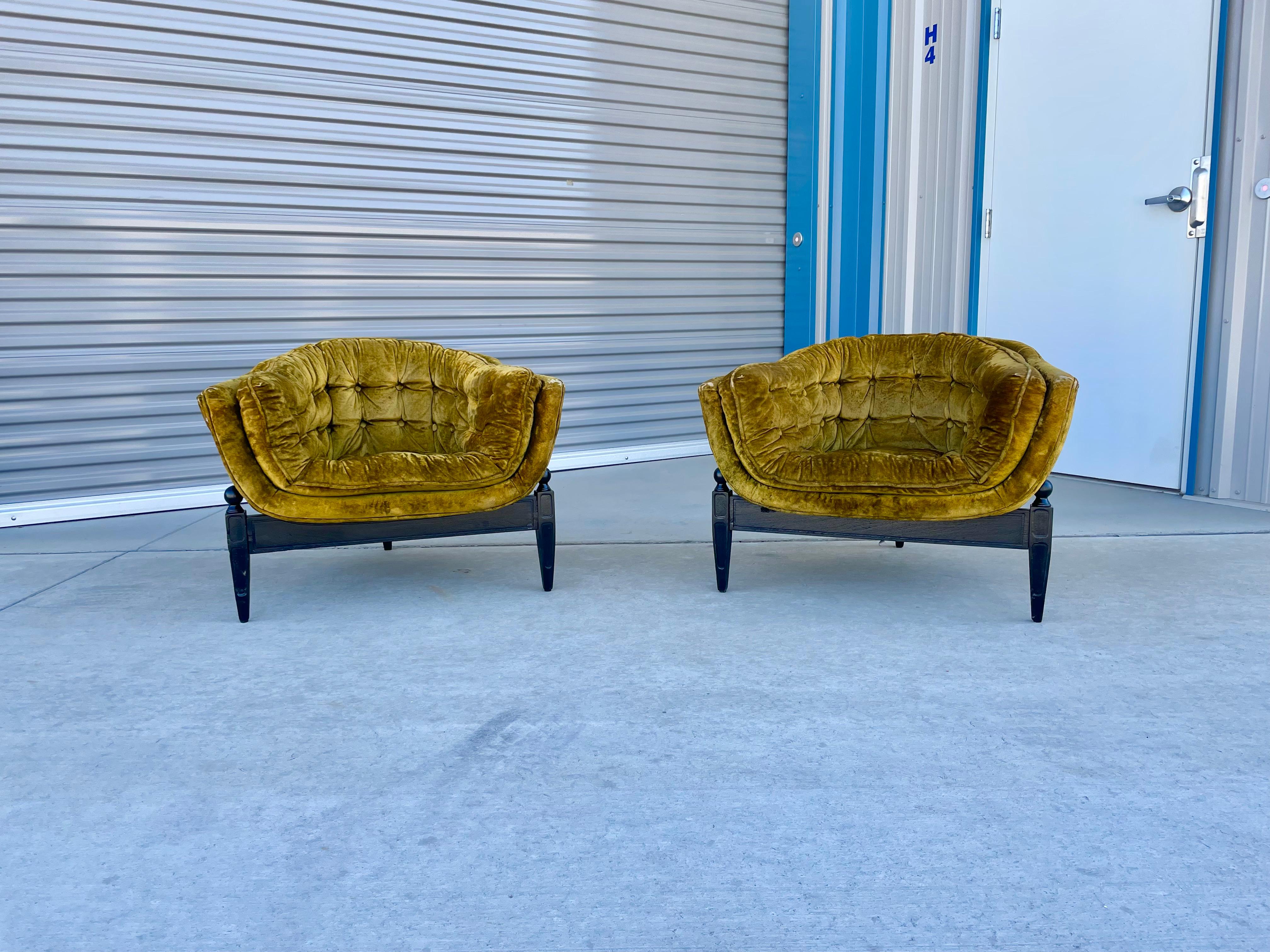 Mid-century lounge chairs were designed and manufactured by Castro Convertibles circa 1960s. These chairs feature green tufted upholstery with a wide curved backrest, which offers solid support and comfort for your back. The chairs also feature a