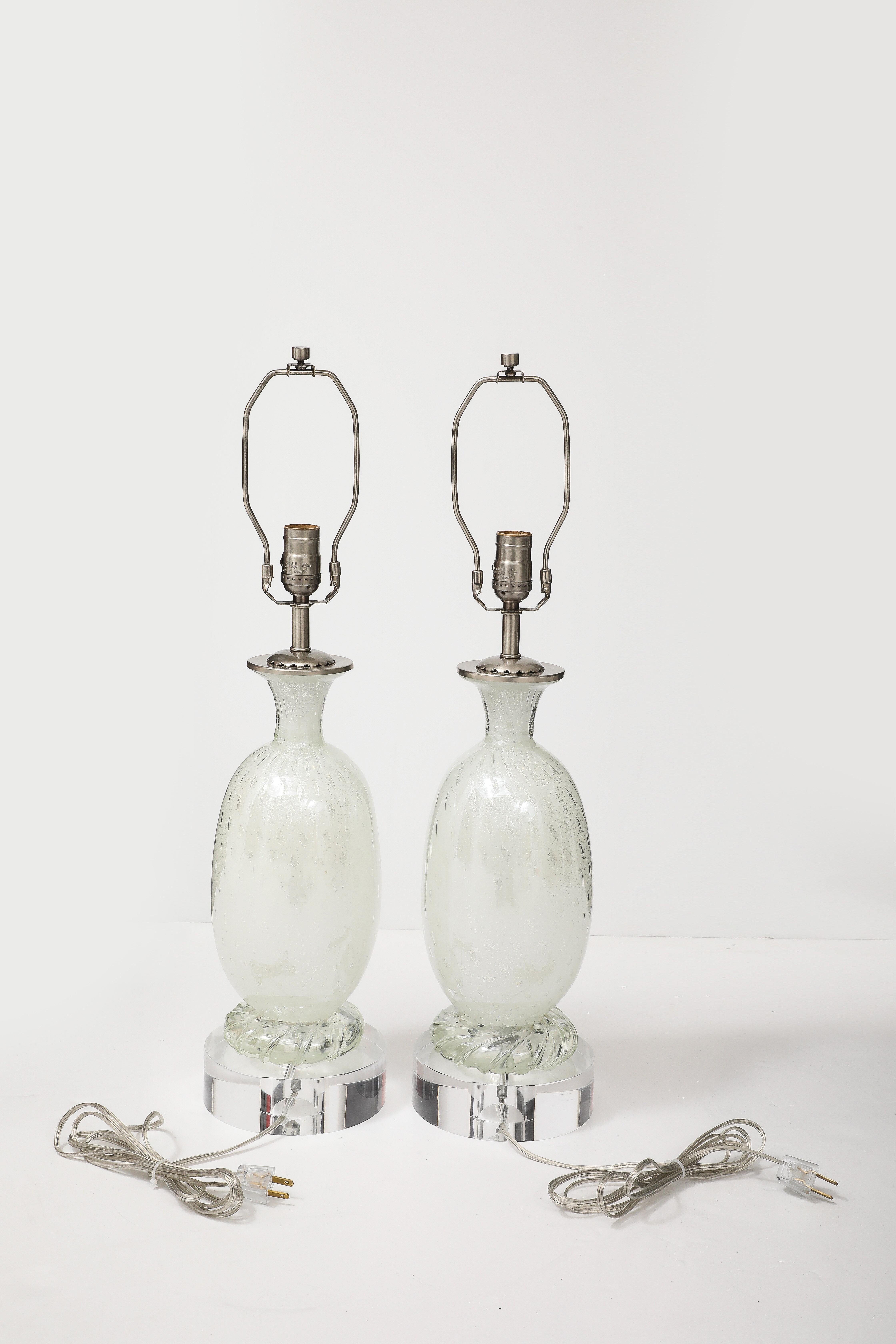 Pair of exceptional white Murano glass lamps with controilled bubble and silver fleck inclusions. Lamps have been rewired to USA standards by a professional UL listed electrician. Lamps sit on ustom Lucite disc bases.