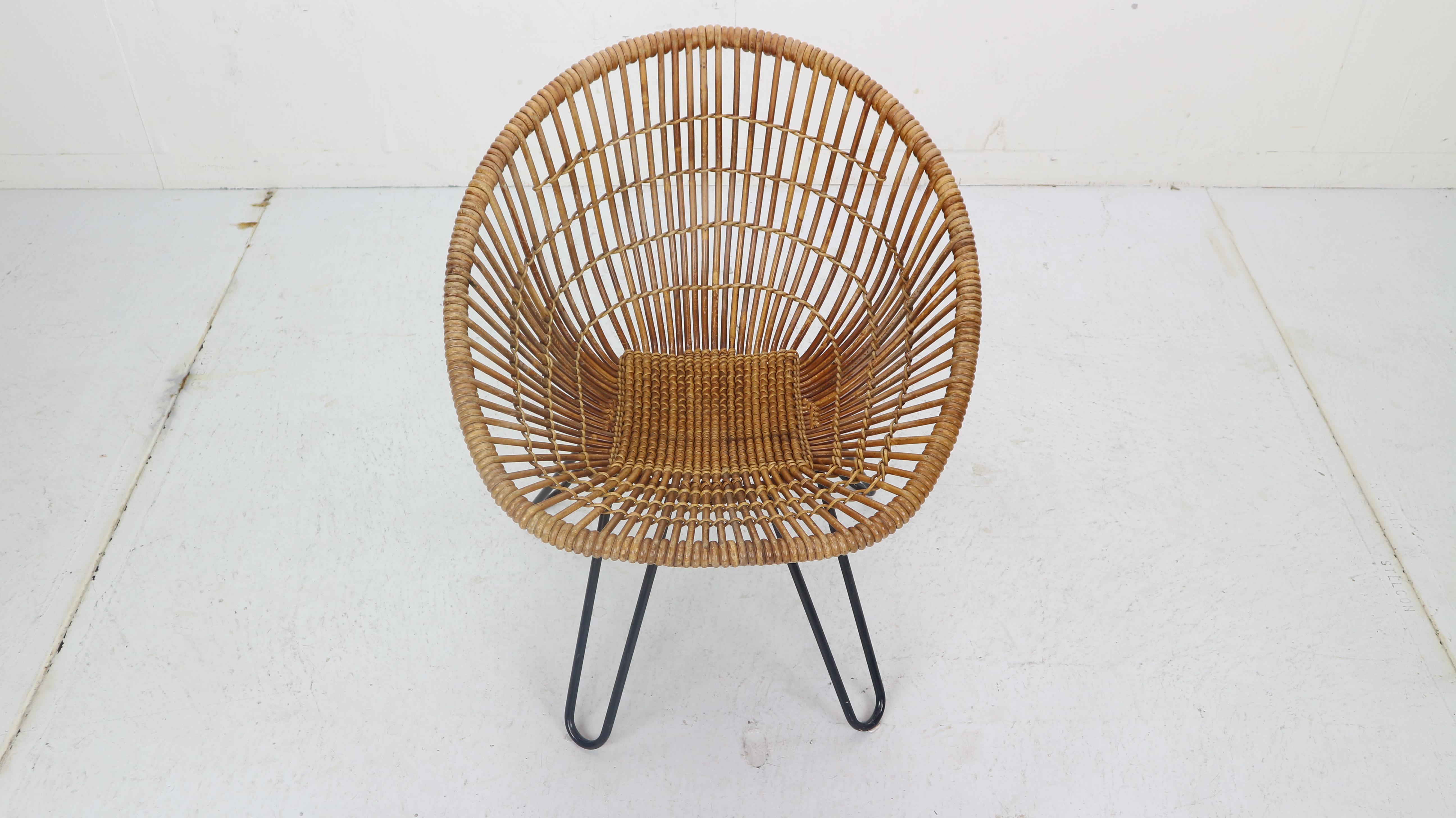 Beautiful lounge chair witch can be used for inside and outside.
Made in 1950s period The Netherlands. 
Minimalistic chair is made of woven rattan base ( has a small damage due to it's vintage age and use, please see the pictures) and strong black