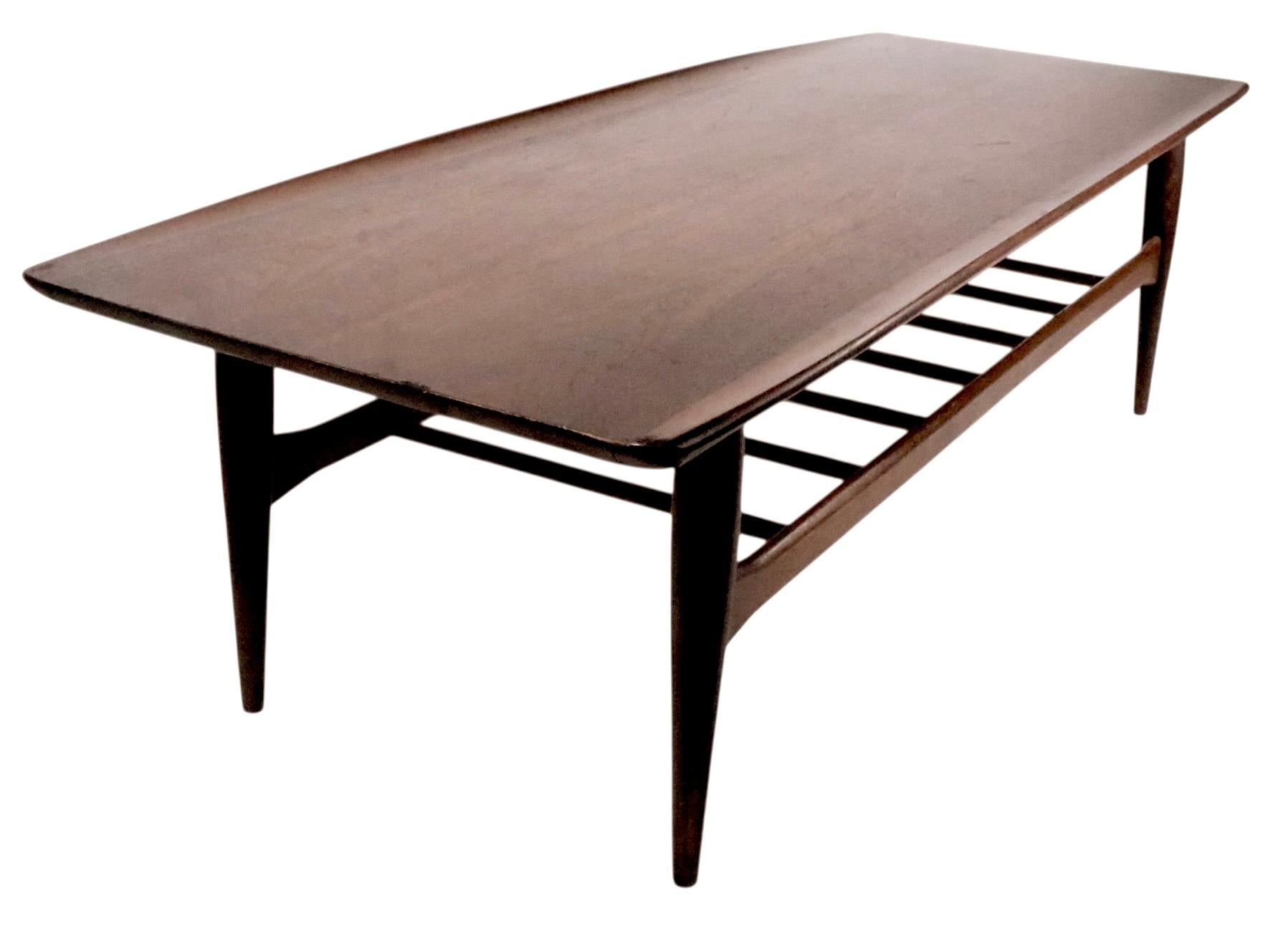 Classic Mid Century Danish Modern style surfboard coffee table by  Bassett as part of the Artisan series c. 1960's. This example is in good, original, clean and ready to use condition, shows light cosmetic wear and minor touch ups, please see