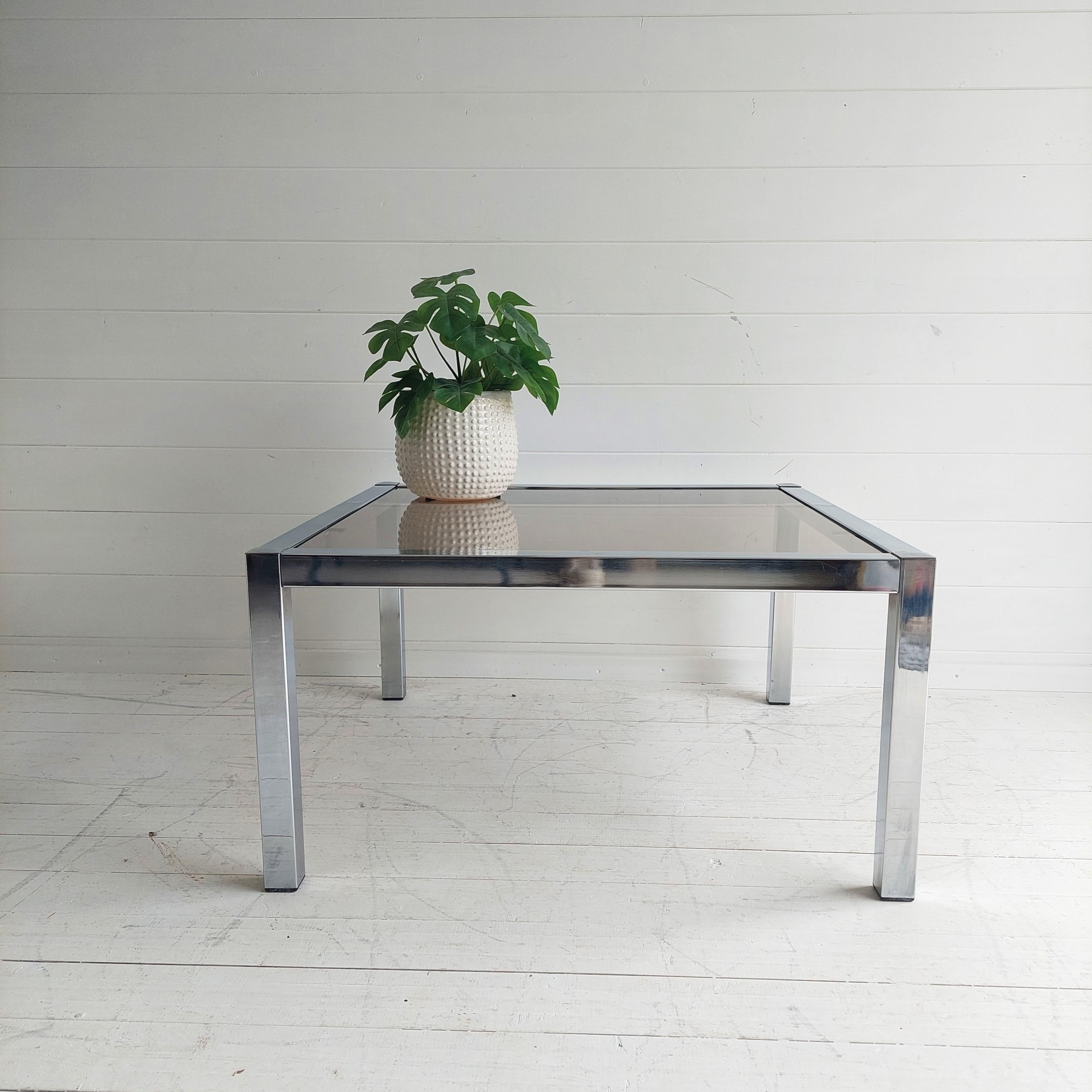 A stunning mid-century Pieff Styled coffee table in smoked glass and chrome.

A useful and decorative square coffee table of classic design
With a minimal and simple lines that will match any styled home.
Square frame and square legs with