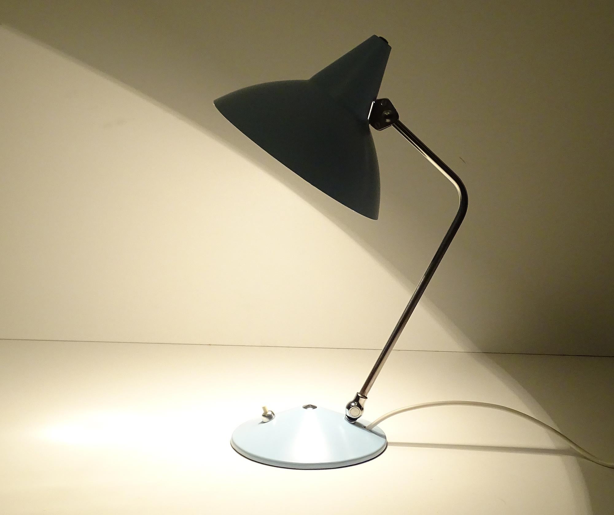 Midcentury table / desk lamp by Helo with signature witch Hat cap, the stem and shade´s angle are both adjustable, pastel blue enameled shade and base, chromed stem
Rewired and ready for use in any country of the world. 
It comes with a standard