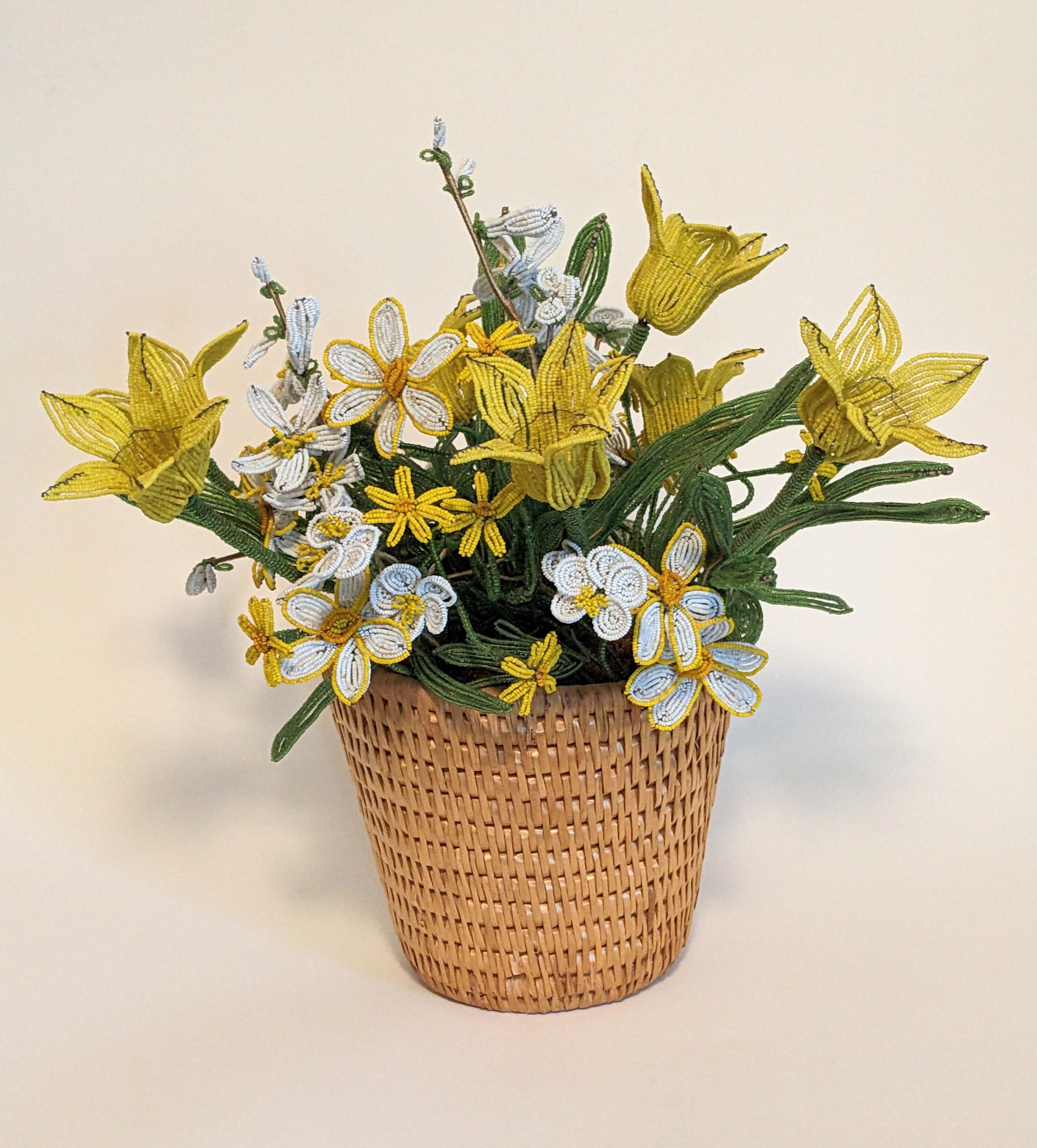 Beaded Tulips Arrangement from the 1960's. The rage for beaded flowers started in the 1960's and ornate labor intensive, professionally made pots were de rigeur in many households throughout the country. 
Pot of hand made Yellow tulips with varied