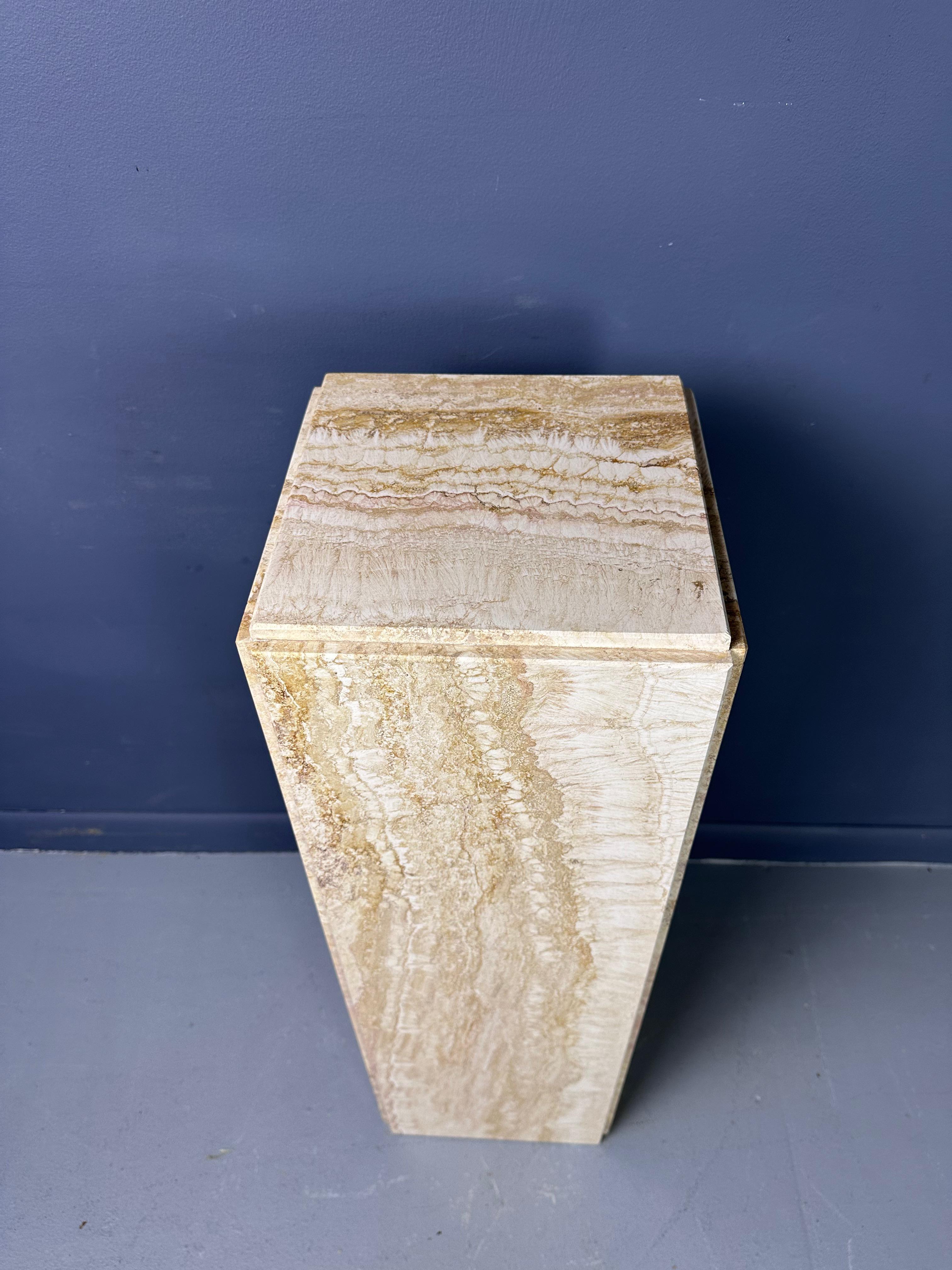 A fine Mid-Century Modern Italian travertine pedastal. With chamfered panels to each side, a rich variegation to the stone, and a smooth polished surface. This piece will certainly compliment any piece of statuary of plant you might want to place on