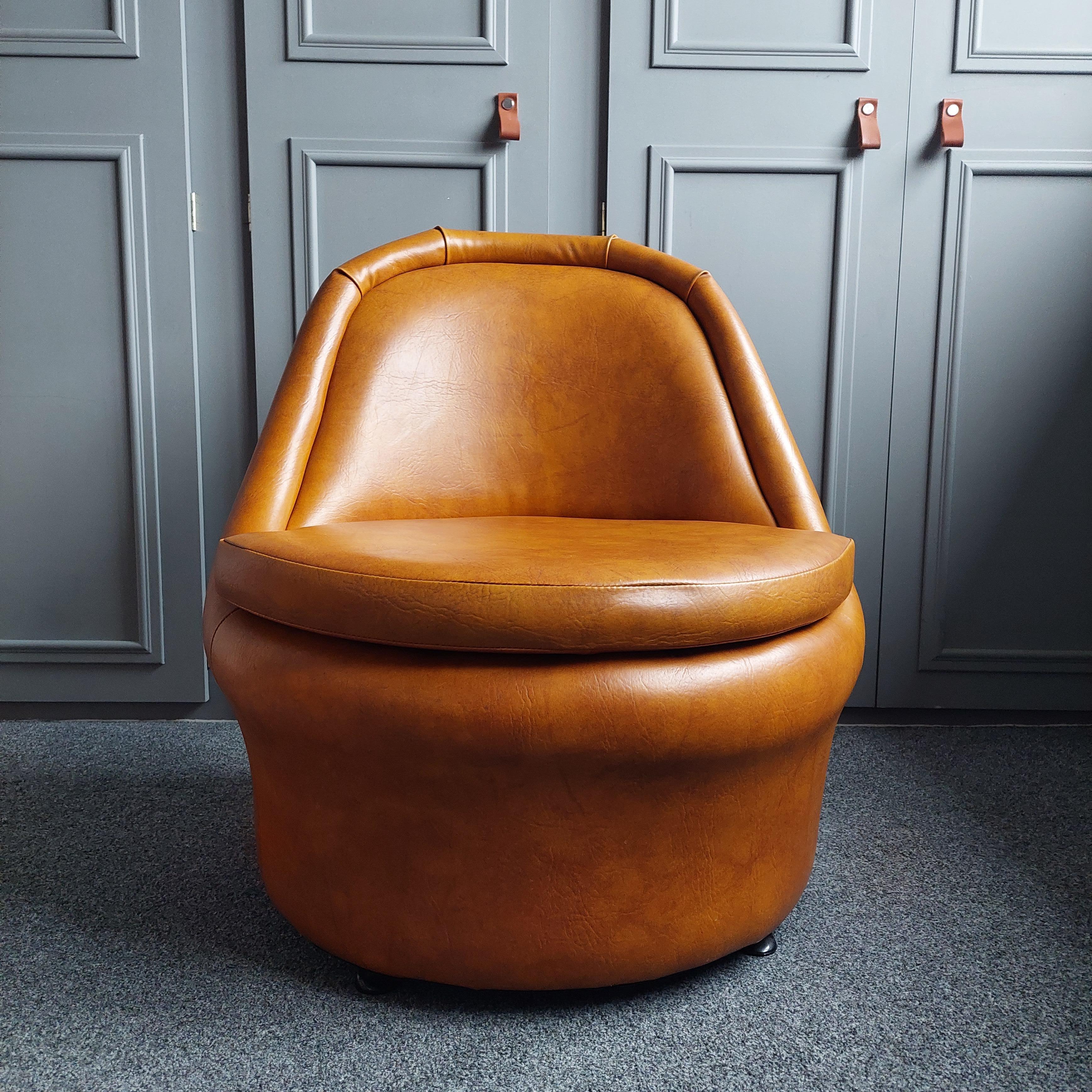 Stunning Tan Leatherette British Cocktail Chair, with the most amazing shape and colour.
Made in England by Sherbourne there are lots of examples of these but we have never seen one with this upholstery before.
It's a rare find, chairs were probably