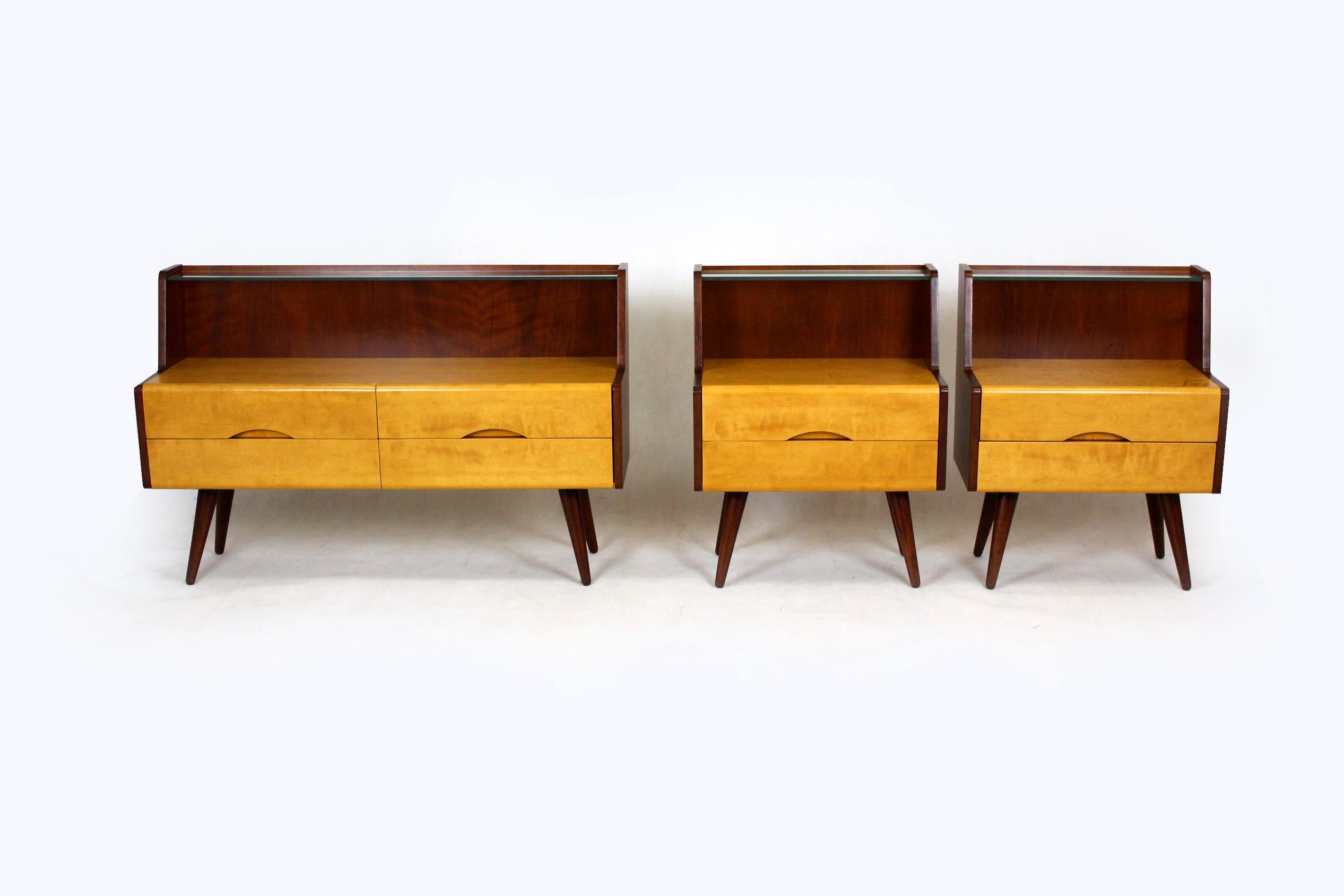 
This bedroom furniture set was produced in Czechslovakia in the 1960s. 
The set consists of two bedside tables and one small chest of drawers. 
The cabinets have been partially restored - the legs and elements made of light wood have been lacquered