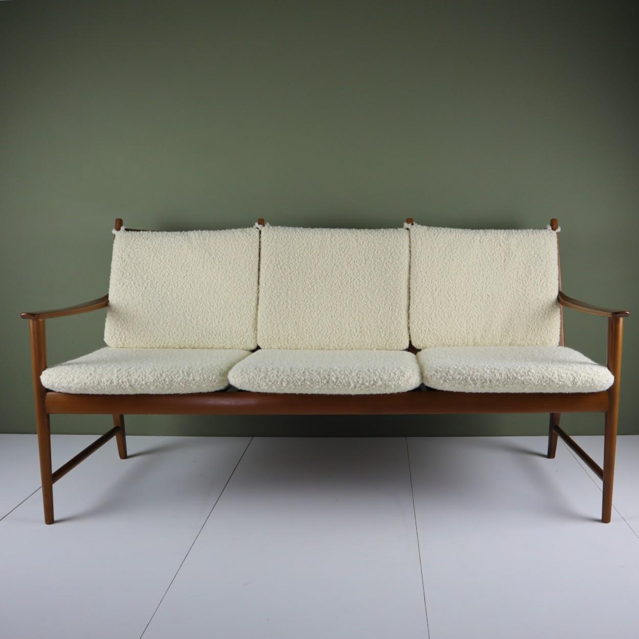 Midcentury sofa in beechwood, reupholstered with an Italian-made off-white bouclé fabric from Designers Guild’s Lana collection.

This sofa was bought at an auction in June of 2021. Its design is a perfect blend of early 20th and midcentury