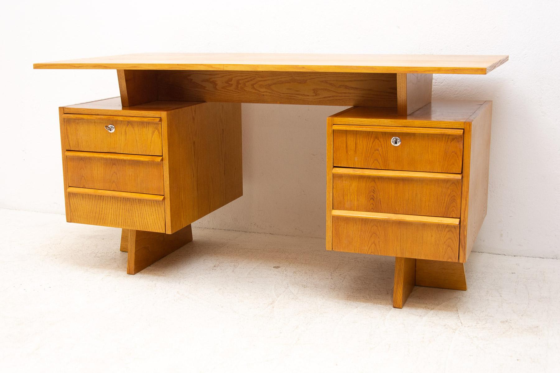 This Mid century writing desk was made in the former Czechoslovakia in 1970s .

The design is very simple and elegant. It features two sections with 6 drawers in total. It´s made of beech wood and plywood.

The piece is fully restored and in